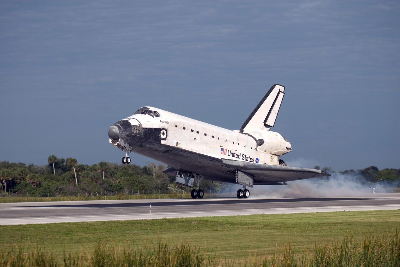 KENNEDY SPACE CENTER, FLA. -- The space shuttle Atlantis kicks up dust as it touches down on Runway 15 of the Shuttle Landing Facility at NASA's Kennedy Space Center.  The shuttle landed on orbit 202 to complete the 13-day STS-122 mission. Main gear touchdown was 9:07:10 a.m. Nose gear touchdown was 9:07:20 a.m. Wheel stop was at 9:08:08 a.m. Mission elapsed time was 12 days, 18 hours, 21 minutes and 44 seconds. During the mission, Atlantis' crew installed the new Columbus laboratory, leaving a larger space station and one with increased science capabilities. The Columbus Research Module adds nearly 1,000 cubic feet of habitable volume and affords room for 10 experiment racks, each an independent science lab. Photo credit: NASA/Chris Lynch