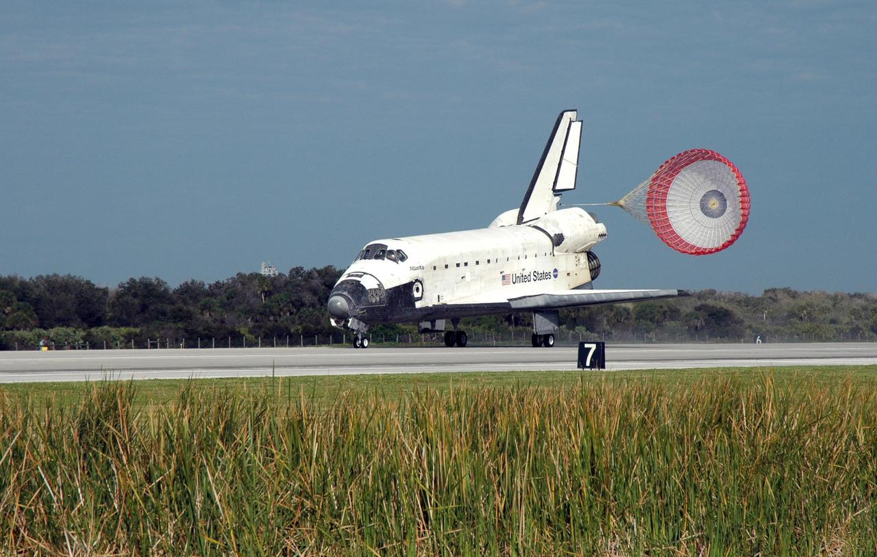 KENNEDY SPACE CENTER, FLA. -- With the aid of a drag chute billowing behind it, space shuttle Atlantis slows to a stop on Runway 15 of the Shuttle Landing Facility at NASA's Kennedy Space Center. The shuttle landed on orbit 202 to complete the 13-day STS-122 mission. Main gear touchdown was 9:07:10 a.m. Nose gear touchdown was 9:07:20 a.m. Wheel stop was at 9:08:08 a.m. Mission elapsed time was 12 days, 18 hours, 21 minutes and 44 seconds. During the mission, Atlantis' crew installed the new Columbus laboratory, leaving a larger space station and one with increased science capabilities. The Columbus Research Module adds nearly 1,000 cubic feet of habitable volume and affords room for 10 experiment racks, each an independent science lab. Photo credit: NASA/Norley Willets
