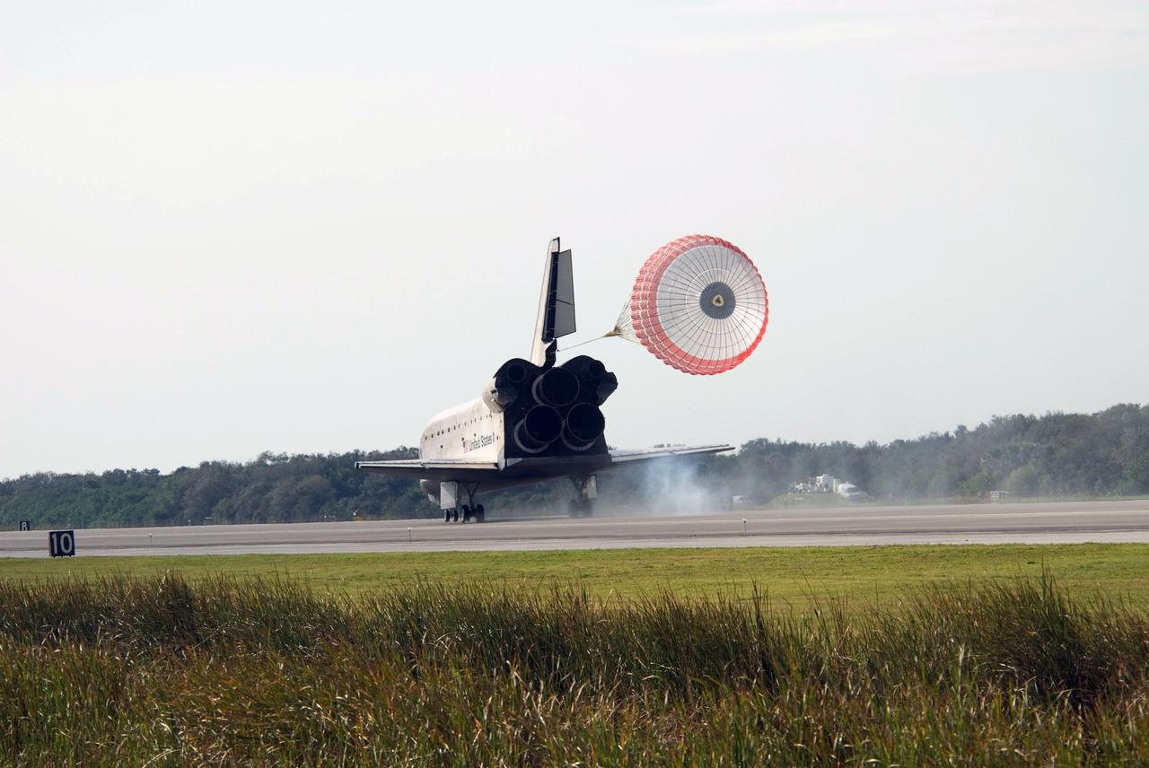 KENNEDY SPACE CENTER, FLA. -- A drag chute continues the slowdown of space shuttle Atlantis as it lands on Runway 15 of the Shuttle Landing Facility at NASA's Kennedy Space Center after a nearly 5.3 million mile round trip to the International Space Station. The shuttle landed on orbit 202 to complete the 13-day STS-122 mission. Main gear touchdown was 9:07:10 a.m. Nose gear touchdown was 9:07:20 a.m. Wheel stop was at 9:08:08 a.m. Mission elapsed time was 12 days, 18 hours, 21 minutes and 44 seconds. During the mission, Atlantis' crew installed the new Columbus laboratory, leaving a larger space station and one with increased science capabilities. The Columbus Research Module adds nearly 1,000 cubic feet of habitable volume and affords room for 10 experiment racks, each an independent science lab. Photo credit: NASA/Kevin O'Connell