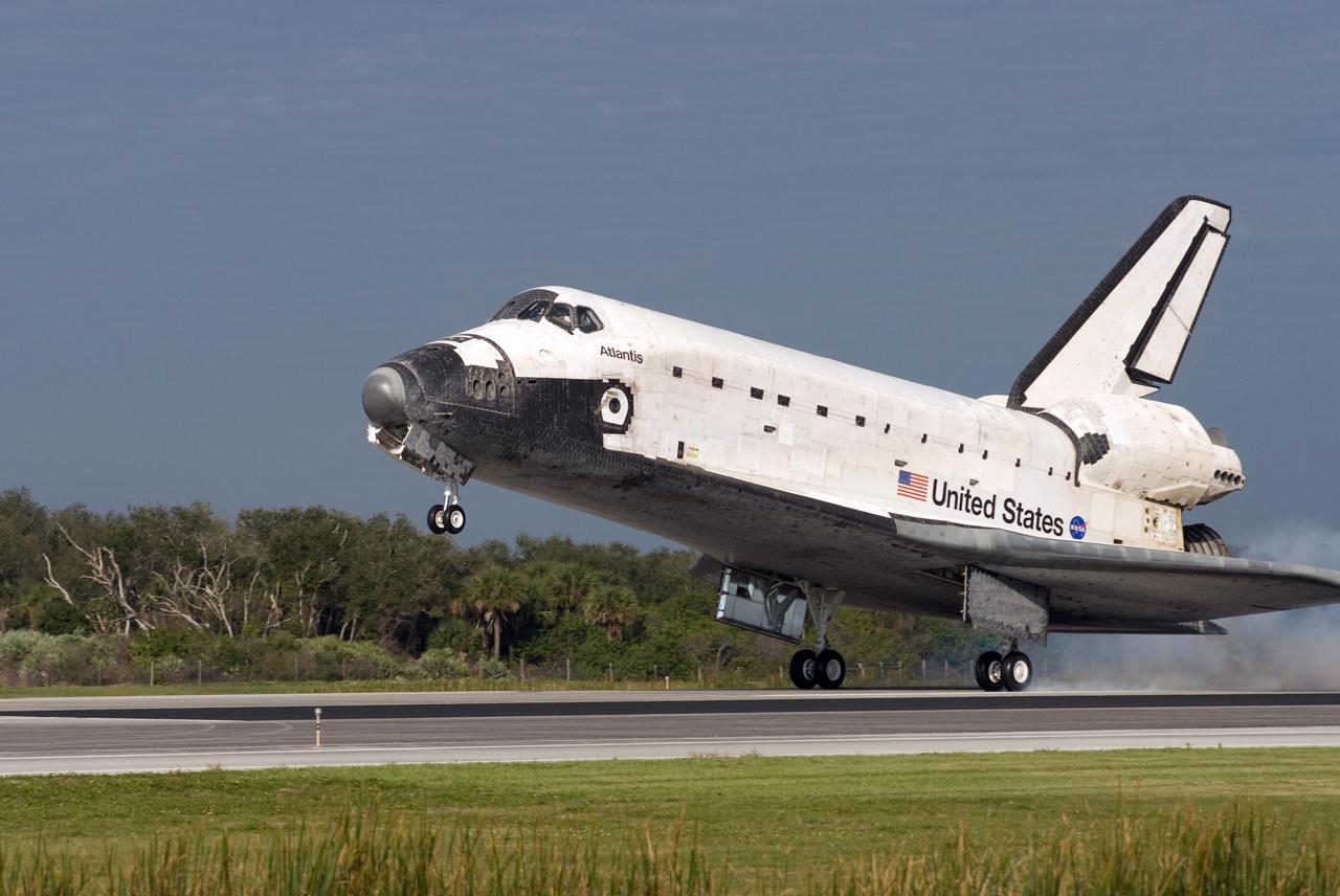 KENNEDY SPACE CENTER, FLA. -- The space shuttle Atlantis kicks up dust as it touches down on Runway 15 of the Shuttle Landing Facility at NASA's Kennedy Space Center. The shuttle landed on orbit 202 to complete the 13-day STS-122 mission. Main gear touchdown was 9:07:10 a.m. Nose gear touchdown was 9:07:20 a.m. Wheel stop was at 9:08:08 a.m. Mission elapsed time was 12 days, 18 hours, 21 minutes and 44 seconds. During the mission, Atlantis' crew installed the new Columbus laboratory, leaving a larger space station and one with increased science capabilities. The Columbus Research Module adds nearly 1,000 cubic feet of habitable volume and affords room for 10 experiment racks, each an independent science lab. Photo credit: NASA/Tom Joseph