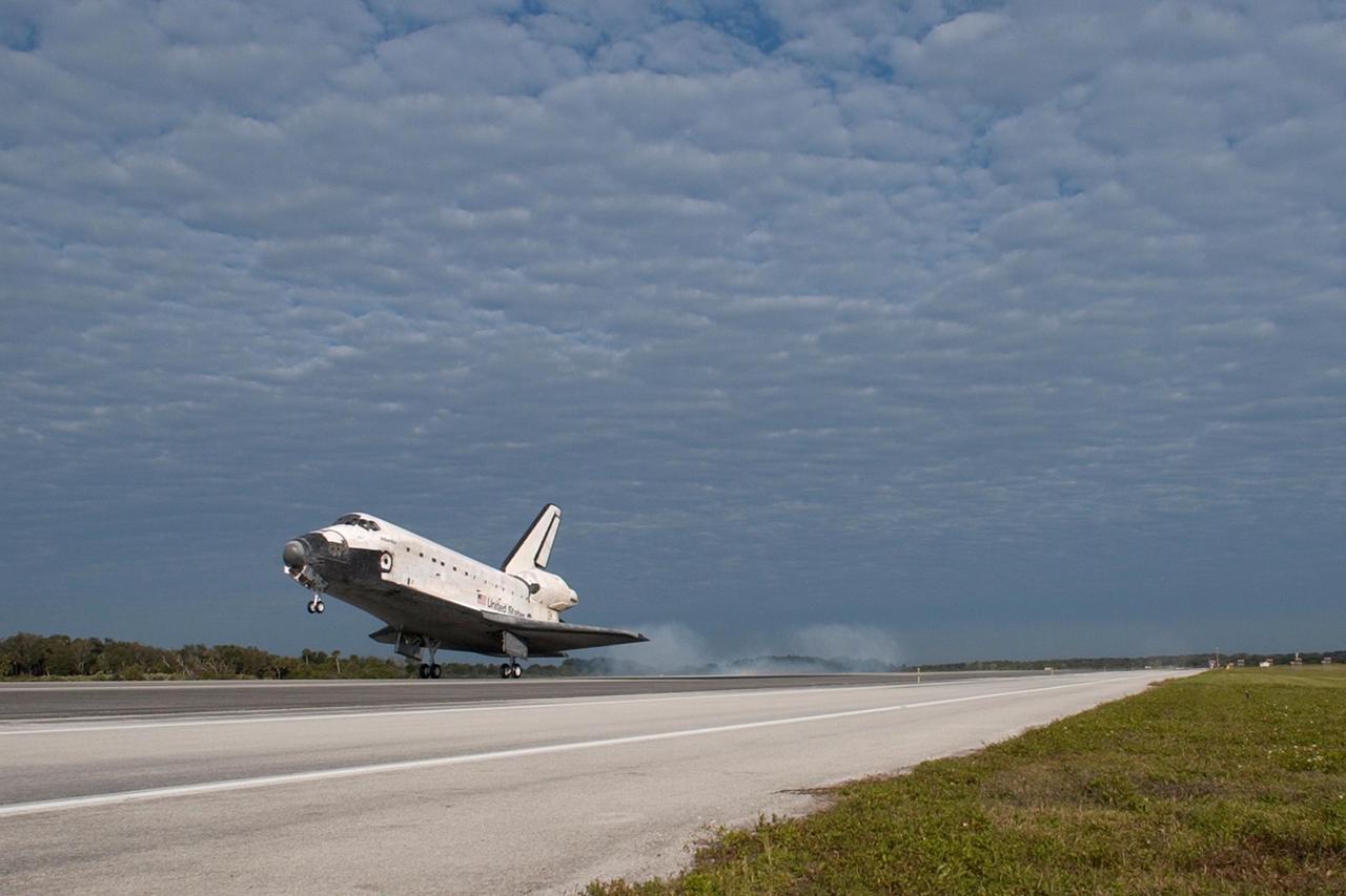 KENNEDY SPACE CENTER, FLA. -- Under a cloud-covered sky, space shuttle Atlantis touches down on Runway 15 of the Shuttle Landing Facility at NASA's Kennedy Space Center. The shuttle landed on orbit 202 to complete the 13-day STS-122 mission. Main gear touchdown was 9:07:10 a.m. Nose gear touchdown was 9:07:20 a.m. Wheel stop was at 9:08:08 a.m. Mission elapsed time was 12 days, 18 hours, 21 minutes and 44 seconds. During the mission, Atlantis' crew installed the new Columbus laboratory, leaving a larger space station and one with increased science capabilities. The Columbus Research Module adds nearly 1,000 cubic feet of habitable volume and affords room for 10 experiment racks, each an independent science lab. Photo credit: NASA/Tony Gray and Scott Haun