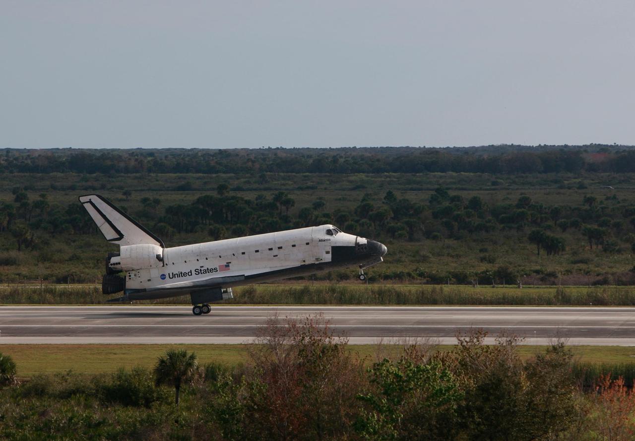 KENNEDY SPACE CENTER, FLA. -- Space shuttle Atlantis touches down on Runway 15 of the Shuttle Landing Facility at NASA's Kennedy Space Center after a nearly 5.3 million mile round trip to the International Space Station. The shuttle landed on orbit 202 to complete the 13-day STS-122 mission. Main gear touchdown was 9:07:10 a.m. Nose gear touchdown was 9:07:20 a.m. Wheel stop was at 9:08:08 a.m. Mission elapsed time was 12 days, 18 hours, 21 minutes and 44 seconds. During the mission, Atlantis' crew installed the new Columbus laboratory, leaving a larger space station and one with increased science capabilities. The Columbus Research Module adds nearly 1,000 cubic feet of habitable volume and affords room for 10 experiment racks, each an independent science lab. Photo courtesy of Scott Andrews