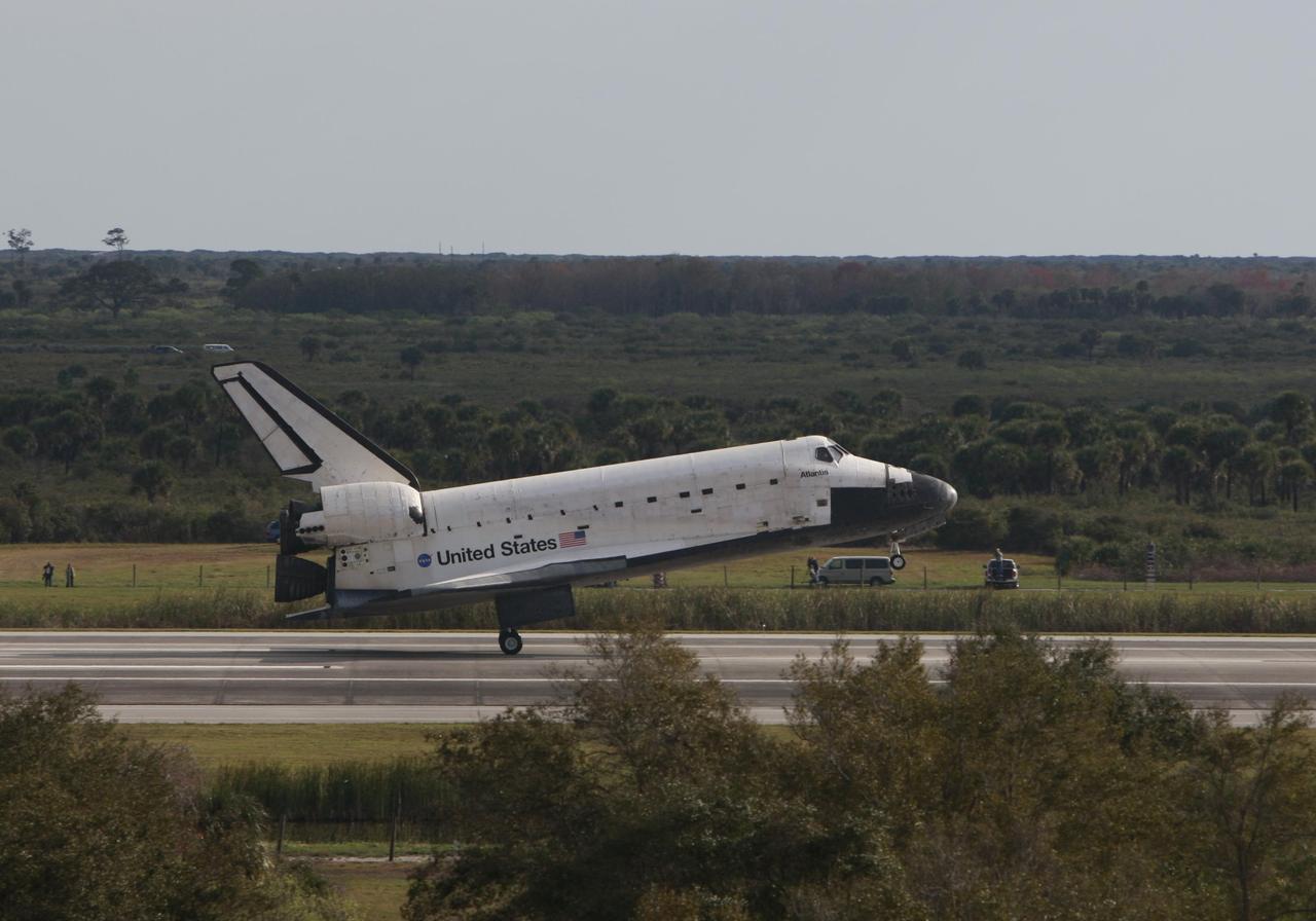 KENNEDY SPACE CENTER, FLA. -- Space shuttle Atlantis touches down on Runway 15 of the Shuttle Landing Facility at NASA's Kennedy Space Center after a nearly 5.3 million mile round trip to the International Space Station. The shuttle landed on orbit 202 to complete the 13-day STS-122 mission. Main gear touchdown was 9:07:10 a.m. Nose gear touchdown was 9:07:20 a.m. Wheel stop was at 9:08:08 a.m. Mission elapsed time was 12 days, 18 hours, 21 minutes and 44 seconds. During the mission, Atlantis' crew installed the new Columbus laboratory, leaving a larger space station and one with increased science capabilities. The Columbus Research Module adds nearly 1,000 cubic feet of habitable volume and affords room for 10 experiment racks, each an independent science lab. Photo courtesy of Scott Andrews