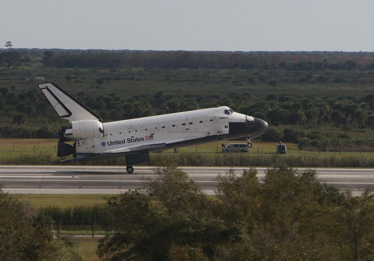 KENNEDY SPACE CENTER, FLA. -- Space shuttle Atlantis touches down on Runway 15 of the Shuttle Landing Facility at NASA's Kennedy Space Center after a nearly 5.3 million mile round trip to the International Space Station. The shuttle landed on orbit 202 to complete the 13-day STS-122 mission. Main gear touchdown was 9:07:10 a.m. Nose gear touchdown was 9:07:20 a.m. Wheel stop was at 9:08:08 a.m. Mission elapsed time was 12 days, 18 hours, 21 minutes and 44 seconds. During the mission, Atlantis' crew installed the new Columbus laboratory, leaving a larger space station and one with increased science capabilities. The Columbus Research Module adds nearly 1,000 cubic feet of habitable volume and affords room for 10 experiment racks, each an independent science lab. Photo courtesy of Scott Andrews