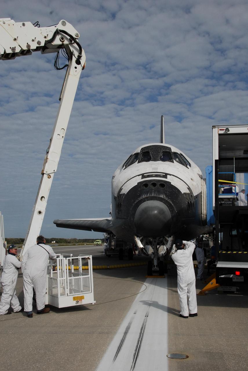 KENNEDY SPACE CENTER, FLA. -- On Runway 15 at NASA's Kennedy Space Center, workers begin preparing space shuttle Atlantis to be towed from the Shuttle Landing Facility. After a round trip of nearly 5.3 million miles, Atlantis and crew returned to Earth with a landing at 9:07 a.m. EST. The shuttle landed on orbit 202 to complete the 13-day STS-122 mission. Main gear touchdown was 9:07:10 a.m. Nose gear touchdown was 9:07:20 a.m. Wheel stop was at 9:08:08 a.m. Mission elapsed time was 12 days, 18 hours, 21 minutes and 44 seconds. During the mission, Atlantis' crew installed the new Columbus laboratory, leaving a larger space station and one with increased science capabilities. The Columbus Research Module adds nearly 1,000 cubic feet of habitable volume and affords room for 10 experiment racks, each an independent science lab. Photo credit: NASA/Jack Pfaller