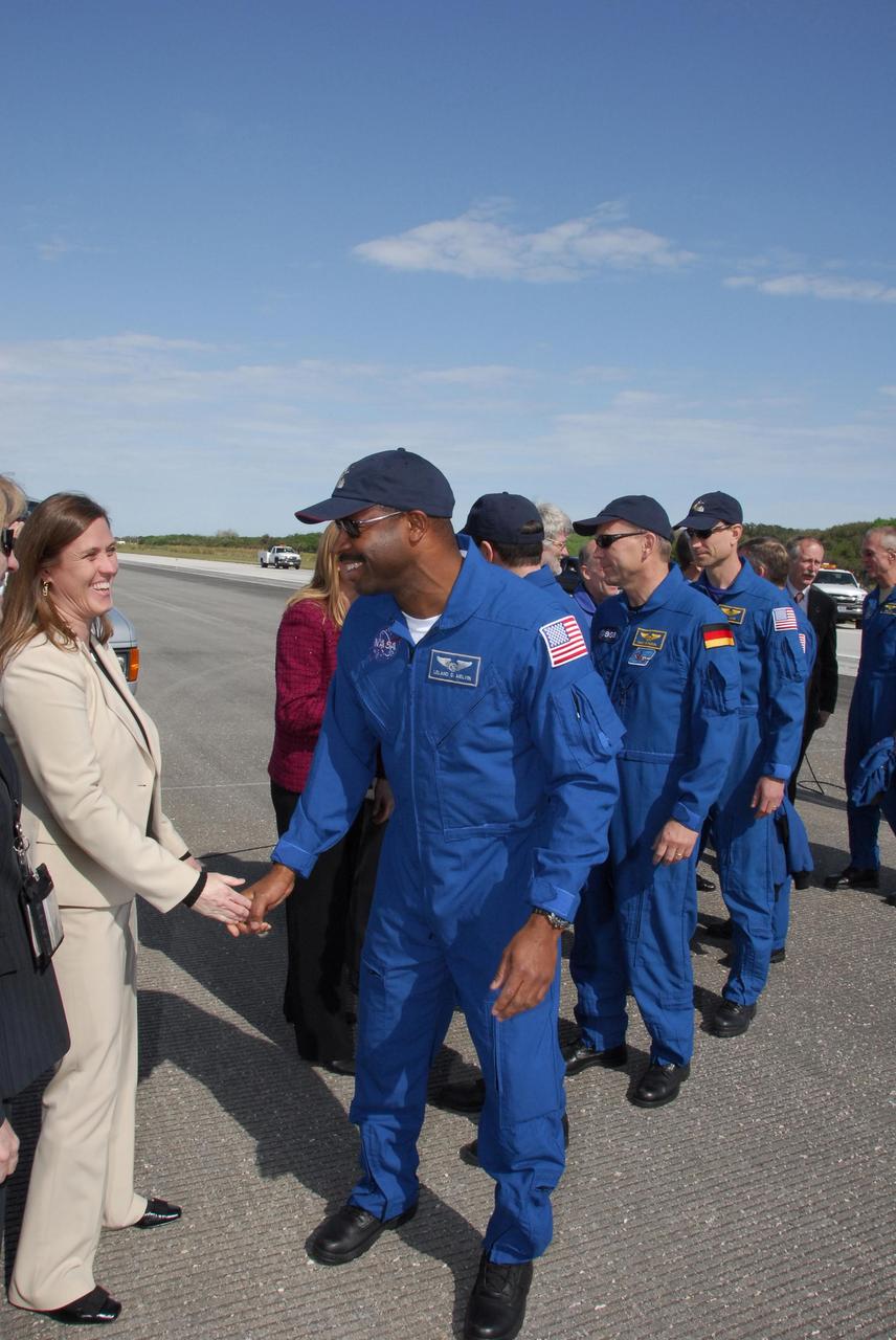 KENNEDY SPACE CENTER, FLA. -- After exiting the crew transport vehicle, STS-122 crewmembers are greeted by NASA VIPs, media and guests. Seen front to back are Mission Specialists Leland Melvin, Rex Walheim, Hans Schlegel and Stanley Love, who represents the European Space Agency. After a round trip of nearly 5.3 million miles, space shuttle Atlantis and crew returned to Earth with a landing at 9:07 a.m. EST. The shuttle landed on orbit 202 to complete the 13-day STS-122 mission. Main gear touchdown was 9:07:10 a.m. Nose gear touchdown was 9:07:20 a.m. Wheel stop was at 9:08:08 a.m. Mission elapsed time was 12 days, 18 hours, 21 minutes and 44 seconds. During the mission, Atlantis' crew installed the new Columbus laboratory, leaving a larger space station and one with increased science capabilities. The Columbus Research Module adds nearly 1,000 cubic feet of habitable volume and affords room for 10 experiment racks, each an independent science lab. Photo credit: NASA/Jack Pfaller