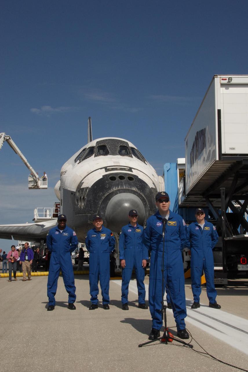 KENNEDY SPACE CENTER, FLA. --  After exiting the crew transport vehicle on the Shuttle Landing Facility at NASA's Kennedy Space Center, the STS-122 crew stands in front of space shuttle Atlantis to greet the media and guests.  At the microphone is Commander Steve Frick.  Behind him, left to right, are Mission Specialists Leland Melvin, Hans Schlegel, Rex Walheim (not visible) and Stanley Love, and Pilot Alan Poindexter.  Schlegel represents the European Space Agency. After a round trip of nearly 5.3 million miles, space shuttle Atlantis and crew returned to Earth with a landing at 9:07 a.m. EST.  The shuttle landed on orbit 202 to complete the 13-day STS-122 mission. Main gear touchdown was 9:07:10 a.m. Nose gear touchdown was 9:07:20 a.m. Wheel stop was at 9:08:08 a.m. Mission elapsed time was 12 days, 18 hours, 21 minutes and 44 seconds. During the mission, Atlantis' crew installed the new Columbus laboratory, leaving a larger space station and one with increased science capabilities. The Columbus Research Module adds nearly 1,000 cubic feet of habitable volume and affords room for 10 experiment racks, each an independent science lab. Photo credit: NASA/Jack Pfaller