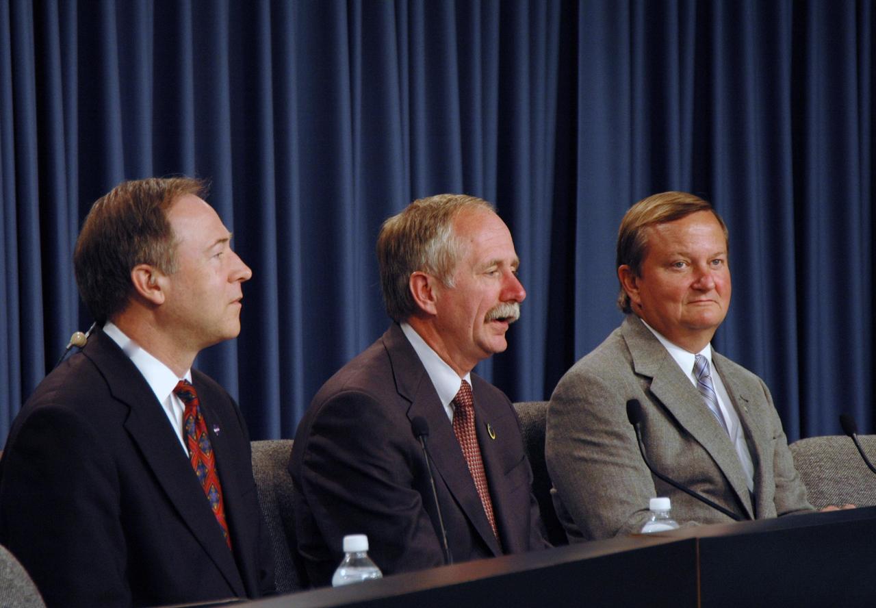 KENNEDY SPACE CENTER, FLA. -- At a post-landing news conference, NASA Associate Administrator for Space Operations William Gerstenmaier (center) responds to a question from the media.  At right is Shuttle Launch Director Mike Leinbach; at left is Assistant Administrator for NASA Public Affairs David Mould.  After a round trip of nearly 5.3 million miles, space shuttle Atlantis and crew returned to Earth with a landing at 9:07 a.m. EST. The shuttle landed on orbit 202 to complete the 13-day STS-122 mission. Main gear touchdown was 9:07:10 a.m. Nose gear touchdown was 9:07:20 a.m. Wheel stop was at 9:08:08 a.m. Mission elapsed time was 12 days, 18 hours, 21 minutes and 44 seconds. During the mission, Atlantis' crew installed the new Columbus laboratory, leaving a larger space station and one with increased science capabilities. The Columbus Research Module adds nearly 1,000 cubic feet of habitable volume and affords room for 10 experiment racks, each an independent science lab. Photo credit: NASA/Jim Grossmann