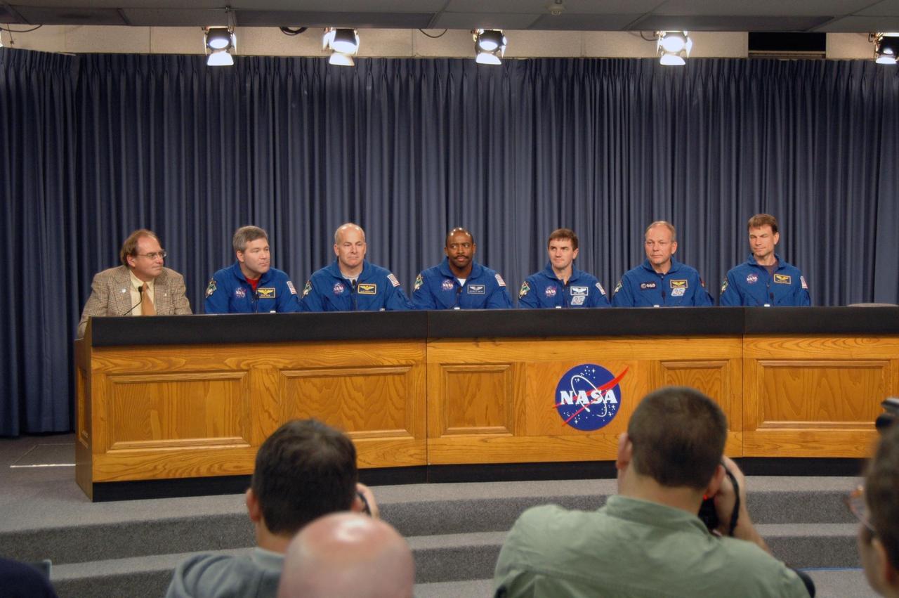 KENNEDY SPACE CENTER, FLA. -- The STS-122 crew discusses its mission at a post-landing conference.  Moderating at left is NASA Public Affairs Officer George Diller.  The crewmembers, from left, are Commander Steve Frick, Pilot Alan Poindexter and Mission Specialists Leland Melvin, Rex Walheim, Hans Schlegel and Stanley Love.   After a round trip of nearly 5.3 million miles, space shuttle Atlantis and crew returned to Earth with a landing at 9:07 a.m. EST on Runway 15 at NASA's Kennedy Space Center.  Photo credit: NASA/Jack Pfaller