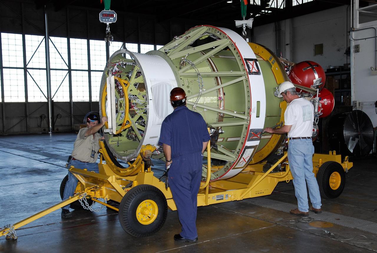 KENNEDY SPACE CENTER, FLA. -- At Cape Canaveral Air Force Station, workers prepare the Delta II second stage for GLAST for weighing. The Delta rocket will be used to launch the Gamma-Ray Large Area Space Telescope, or GLAST, May 16 from Launch Pad 17-B on CCAFS. The GLAST is a powerful space observatory that will explore the Universe's ultimate frontier, where nature harnesses forces and energies far beyond anything possible on Earth;  probe some of science's deepest questions, such as what our Universe is made of, and search for new laws of physics; explain how black holes accelerate jets of material to nearly light speed; and help crack the mystery of stupendously powerful explosions known as gamma-ray bursts.  Photo credit: NASA/Kim Shiflett
