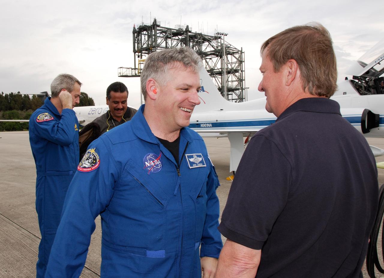KENNEDY SPACE CENTER, FLA. -- STS-123 Pilot Gregory H. Johnson, at left, is greeted by Shuttle Launch Director Mike Leinbach following his arrival at NASA Kennedy Space Center's Shuttle Landing Facility.  The crew for space shuttle Endeavour's STS-123 mission is at Kennedy for a full launch dress rehearsal, known as the terminal countdown demonstration test or TCDT.  Endeavour's seven astronauts arrived at Kennedy's Shuttle Landing Facility in their T-38 training aircraft between 10:45 and 10:58 a.m. EST.  The terminal countdown demonstration test provides astronauts and ground crews with an opportunity to participate in various simulated countdown activities, including equipment familiarization and emergency training. Endeavour is targeted to launch March 11 at 2:28 a.m. EDT on a 16-day mission to the International Space Station.  On the mission, Endeavour and its crew will deliver the first section of the Japan Aerospace Exploration Agency's Kibo laboratory and the Canadian Space Agency's two-armed robotic system, Dextre. Photo credit: NASA/Kim Shiflett
