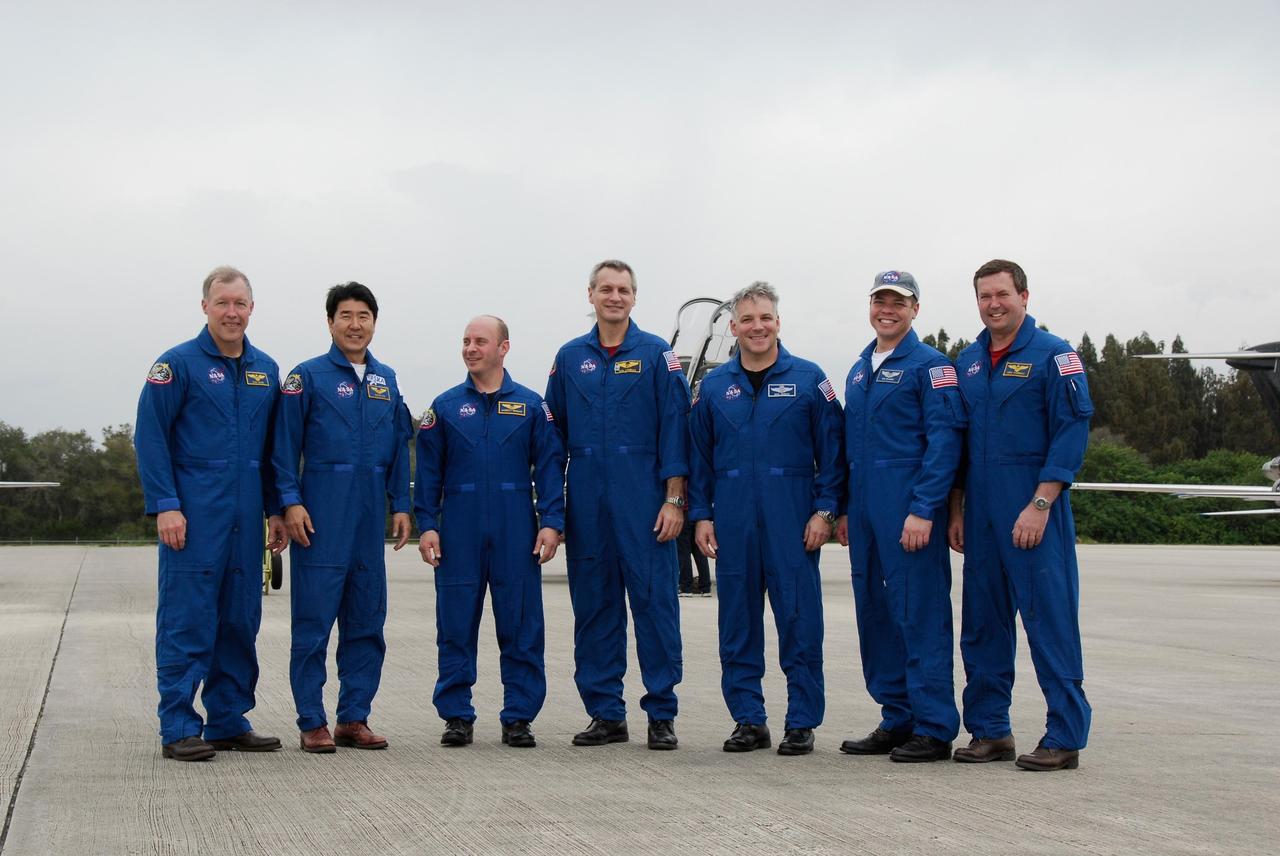 KENNEDY SPACE CENTER, FLA. -- The crew for space shuttle Endeavour's STS-123 mission pose for a group portrait following their arrival at NASA Kennedy Space Center's Shuttle Landing Facility. From left are Commander Dominic Gorie; Mission Specialists Takao Doi of the Japan Aerospace Exploration Agency, Garrett Reisman and Rick Linnehan; Pilot Gregory H. Johnson; and Mission Specialists Robert L. Behnken and Mike Foreman. The crew is at Kennedy for a full launch dress rehearsal, known as the terminal countdown demonstration test or TCDT. Endeavour's seven astronauts arrived at Kennedy's Shuttle Landing Facility in their T-38 training aircraft between 10:45 and 10:58 a.m. EST. The terminal countdown demonstration test provides astronauts and ground crews with an opportunity to participate in various simulated countdown activities, including equipment familiarization and emergency training. Endeavour is targeted to launch March 11 at 2:28 a.m. EDT on a 16-day mission to the International Space Station. On the mission, Endeavour and its crew will deliver the first section of the Japan Aerospace Exploration Agency's Kibo laboratory and the Canadian Space Agency's two-armed robotic system, Dextre. Photo credit: NASA/Kim Shiflett