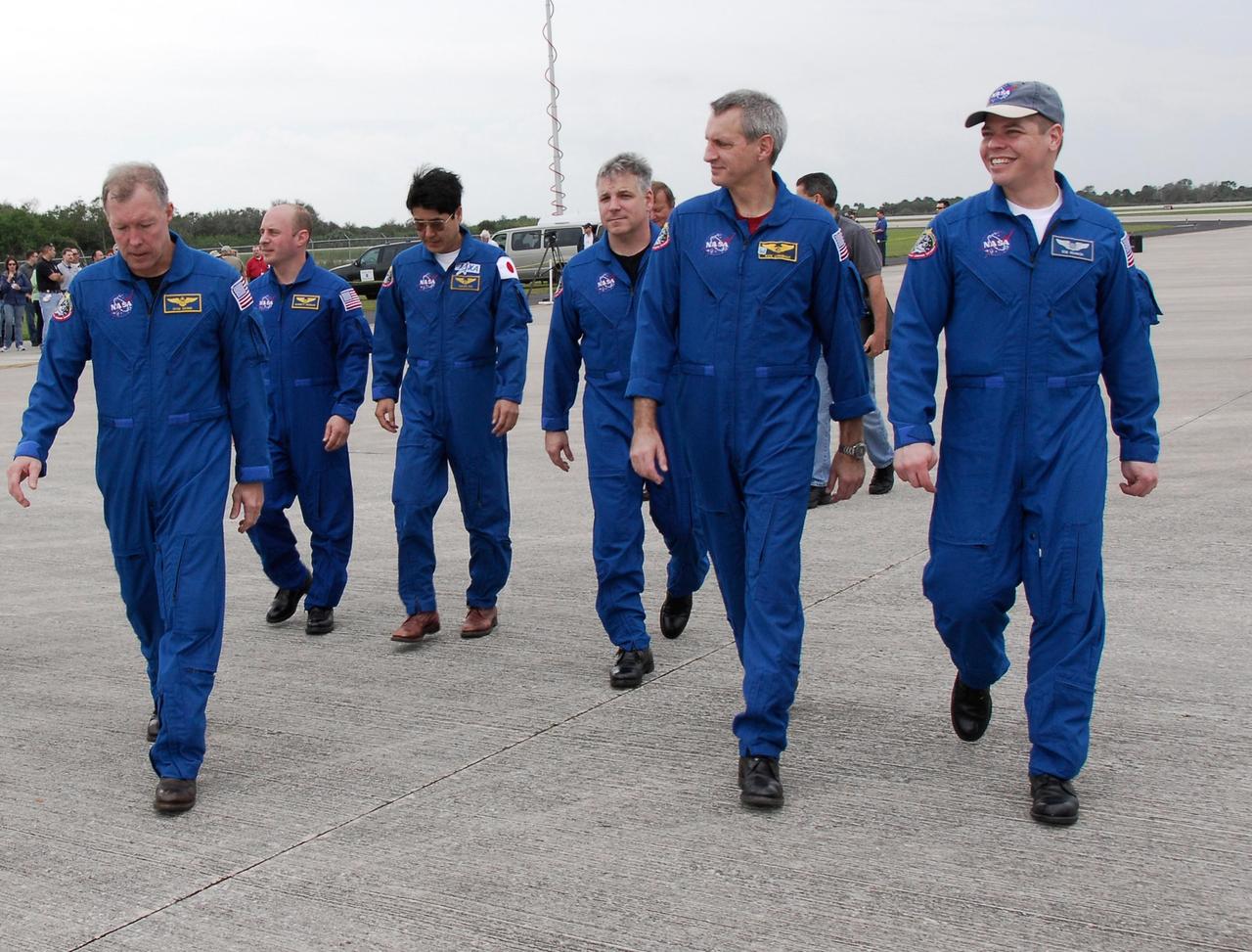 KENNEDY SPACE CENTER, FLA. -- The crew for space shuttle Endeavour's STS-123 mission head for the bus which will transport them to crew quarters following their arrival at NASA Kennedy Space Center's Shuttle Landing Facility. From left are Commander Dominic Gorie; Mission Specialists Garrett Reisman and Takao Doi of the Japan Aerospace Exploration Agency; Pilot Gregory H. Johnson; and Mission Specialists Rick Linnehan and Robert L. Behnken. The crew is at Kennedy for a full launch dress rehearsal, known as the terminal countdown demonstration test or TCDT. Endeavour's seven astronauts arrived at Kennedy's Shuttle Landing Facility in their T-38 training aircraft between 10:45 and 10:58 a.m. EST. The terminal countdown demonstration test provides astronauts and ground crews with an opportunity to participate in various simulated countdown activities, including equipment familiarization and emergency training. Endeavour is targeted to launch March 11 at 2:28 a.m. EDT on a 16-day mission to the International Space Station. On the mission, Endeavour and its crew will deliver the first section of the Japan Aerospace Exploration Agency's Kibo laboratory and the Canadian Space Agency's two-armed robotic system, Dextre. Photo credit: NASA/Kim Shiflett