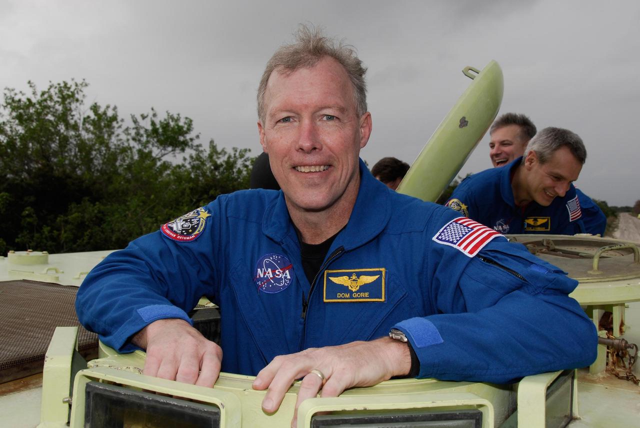 KENNEDY SPACE CENTER, FLA. -- At NASA Kennedy Space Center's Launch Complex 39, STS-123 Commander Dominic Gorie takes time out from driving practice of the M-113 armored personnel carrier to pose for a photo.  The crew members of space shuttle Endeavour's STS-123 mission will each practice driving the M-113 in turn as part of his training on emergency egress procedures.  An M-113 will be available to transport the crew to safety in the event of a contingency on the pad before their launch.  The STS-123 crew is at Kennedy for a full launch dress rehearsal, known as the terminal countdown demonstration test or TCDT.  Endeavour's seven astronauts arrived at Kennedy's Shuttle Landing Facility in their T-38 training aircraft between 10:45 and 10:58 a.m. EST. The terminal countdown demonstration test provides astronauts and ground crews with an opportunity to participate in various simulated countdown activities, including equipment familiarization and emergency training. Endeavour is targeted to launch March 11 at 2:28 a.m. EDT on a 16-day mission to the International Space Station. On the mission, Endeavour and its crew will deliver the first section of the Japan Aerospace Exploration Agency's Kibo laboratory and the Canadian Space Agency's two-armed robotic system, Dextre. Photo credit: NASA/Kim Shiflett