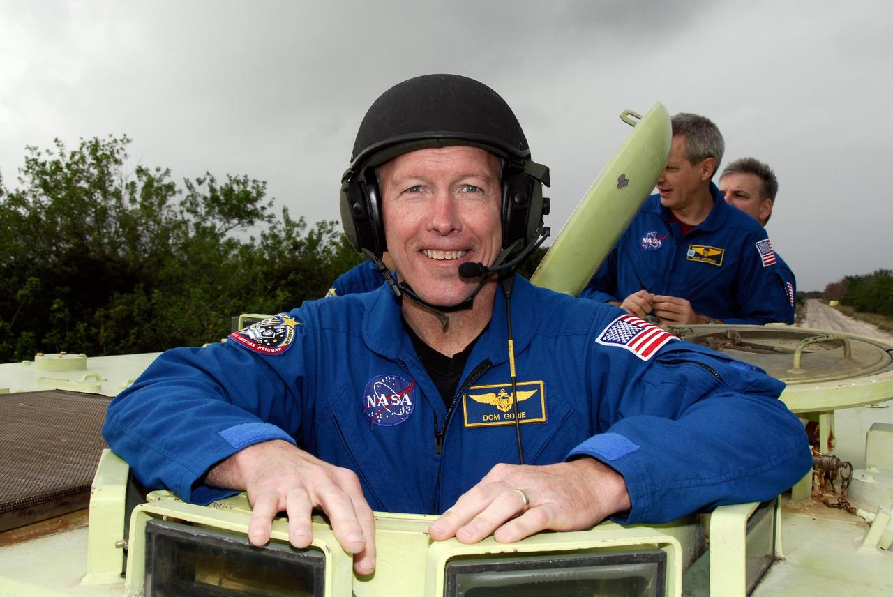 KENNEDY SPACE CENTER, FLA. -- At NASA Kennedy Space Center's Launch Complex 39, STS-123 Commander Dominic Gorie takes time out from driving practice of the M-113 armored personnel carrier to pose for a photo.  The crew members of space shuttle Endeavour's STS-123 mission will each practice driving the M-113 in turn as part of his training on emergency egress procedures.  An M-113 will be available to transport the crew to safety in the event of a contingency on the pad before their launch.  The STS-123 crew is at Kennedy for a full launch dress rehearsal, known as the terminal countdown demonstration test or TCDT.  Endeavour's seven astronauts arrived at Kennedy's Shuttle Landing Facility in their T-38 training aircraft between 10:45 and 10:58 a.m. EST. The terminal countdown demonstration test provides astronauts and ground crews with an opportunity to participate in various simulated countdown activities, including equipment familiarization and emergency training. Endeavour is targeted to launch March 11 at 2:28 a.m. EDT on a 16-day mission to the International Space Station. On the mission, Endeavour and its crew will deliver the first section of the Japan Aerospace Exploration Agency's Kibo laboratory and the Canadian Space Agency's two-armed robotic system, Dextre. Photo credit: NASA/Kim Shiflett