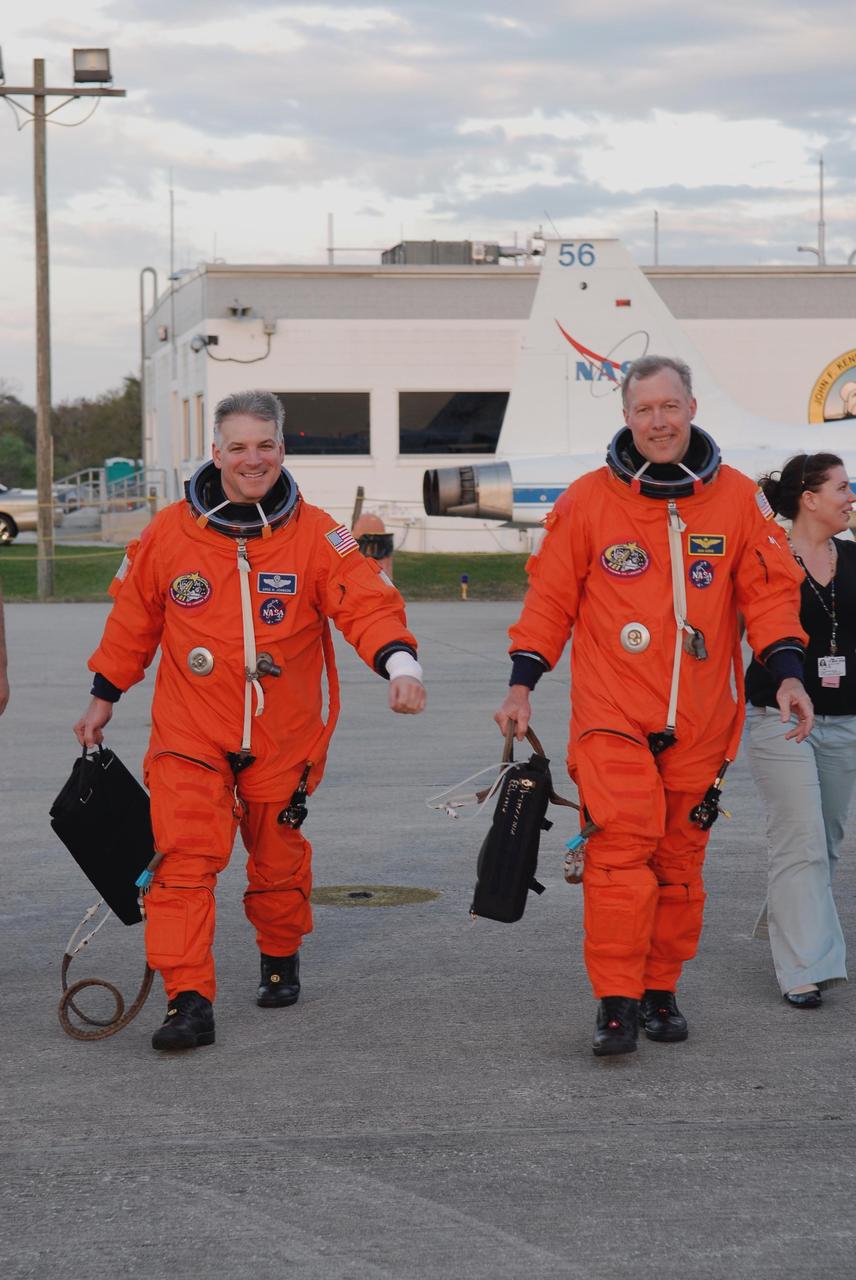 KENNEDY SPACE CENTER, FLA. -- At NASA Kennedy Space Center's Shuttle Landing Facility, STS-123 Pilot Gregory H. Johnson, left, and Commander Dominic Gorie prepare to practice space shuttle landings using NASA's Shuttle Training Aircraft, or STA. The STA is a Grumman American Aviation-built Gulf Stream II jet that was modified to simulate an orbiter's cockpit, motion and visual cues, and handling qualities. In flight, the STA duplicates the orbiter's atmospheric descent trajectory from approximately 35,000 feet altitude to landing on a runway. Because the orbiter is unpowered during re-entry and landing, its high-speed glide must be perfectly executed the first time.  The crew for space shuttle Endeavour's STS-123 mission is at Kennedy for a full launch dress rehearsal, known as the terminal countdown demonstration test or TCDT.  The terminal countdown demonstration test provides astronauts and ground crews with an opportunity to participate in various simulated countdown activities, including equipment familiarization and emergency training. Endeavour is targeted to launch March 11 at 2:28 a.m. EDT on a 16-day mission to the International Space Station. On the mission, Endeavour and its crew will deliver the first section of the Japan Aerospace Exploration Agency's Kibo laboratory and the Canadian Space Agency's two-armed robotic system, Dextre. Photo credit: NASA/Kim Shiflett