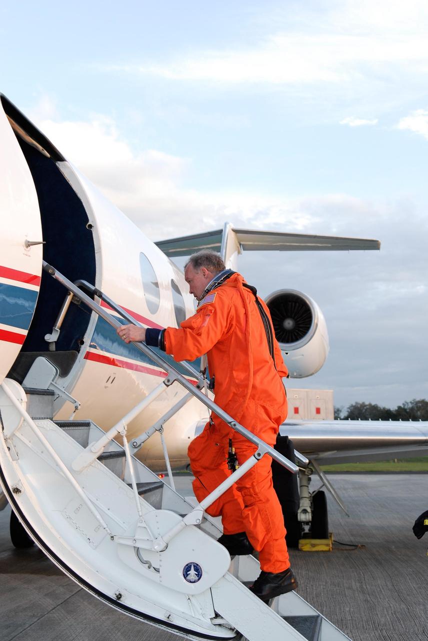 KENNEDY SPACE CENTER, FLA. -- At NASA Kennedy Space Center's Shuttle Landing Facility, STS-123 Commander Dominic Gorie boards a Shuttle Training Aircraft, or STA, to practice space shuttle landings.  The STA is a Grumman American Aviation-built Gulf Stream II jet that was modified to simulate an orbiter's cockpit, motion and visual cues, and handling qualities. In flight, the STA duplicates the orbiter's atmospheric descent trajectory from approximately 35,000 feet altitude to landing on a runway. Because the orbiter is unpowered during re-entry and landing, its high-speed glide must be perfectly executed the first time.  The crew for space shuttle Endeavour's STS-123 mission is at Kennedy for a full launch dress rehearsal, known as the terminal countdown demonstration test or TCDT.  The terminal countdown demonstration test provides astronauts and ground crews with an opportunity to participate in various simulated countdown activities, including equipment familiarization and emergency training. Endeavour is targeted to launch March 11 at 2:28 a.m. EDT on a 16-day mission to the International Space Station. On the mission, Endeavour and its crew will deliver the first section of the Japan Aerospace Exploration Agency's Kibo laboratory and the Canadian Space Agency's two-armed robotic system, Dextre. Photo credit: NASA/Kim Shiflett