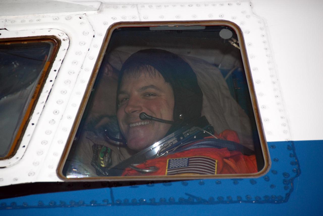 KENNEDY SPACE CENTER, FLA. -- At NASA Kennedy Space Center's Shuttle Landing Facility, STS-123 Pilot Gregory H. Johnson is seen through the window of a Shuttle Training Aircraft, or STA, as he prepares to practice space shuttle landings. The STA is a Grumman American Aviation-built Gulf Stream II jet that was modified to simulate an orbiter's cockpit, motion and visual cues, and handling qualities. In flight, the STA duplicates the orbiter's atmospheric descent trajectory from approximately 35,000 feet altitude to landing on a runway. Because the orbiter is unpowered during re-entry and landing, its high-speed glide must be perfectly executed the first time.  The crew for space shuttle Endeavour's STS-123 mission is at Kennedy for a full launch dress rehearsal, known as the terminal countdown demonstration test or TCDT.  The terminal countdown demonstration test provides astronauts and ground crews with an opportunity to participate in various simulated countdown activities, including equipment familiarization and emergency training. Endeavour is targeted to launch March 11 at 2:28 a.m. EDT on a 16-day mission to the International Space Station. On the mission, Endeavour and its crew will deliver the first section of the Japan Aerospace Exploration Agency's Kibo laboratory and the Canadian Space Agency's two-armed robotic system, Dextre. Photo credit: NASA/Kim Shiflett