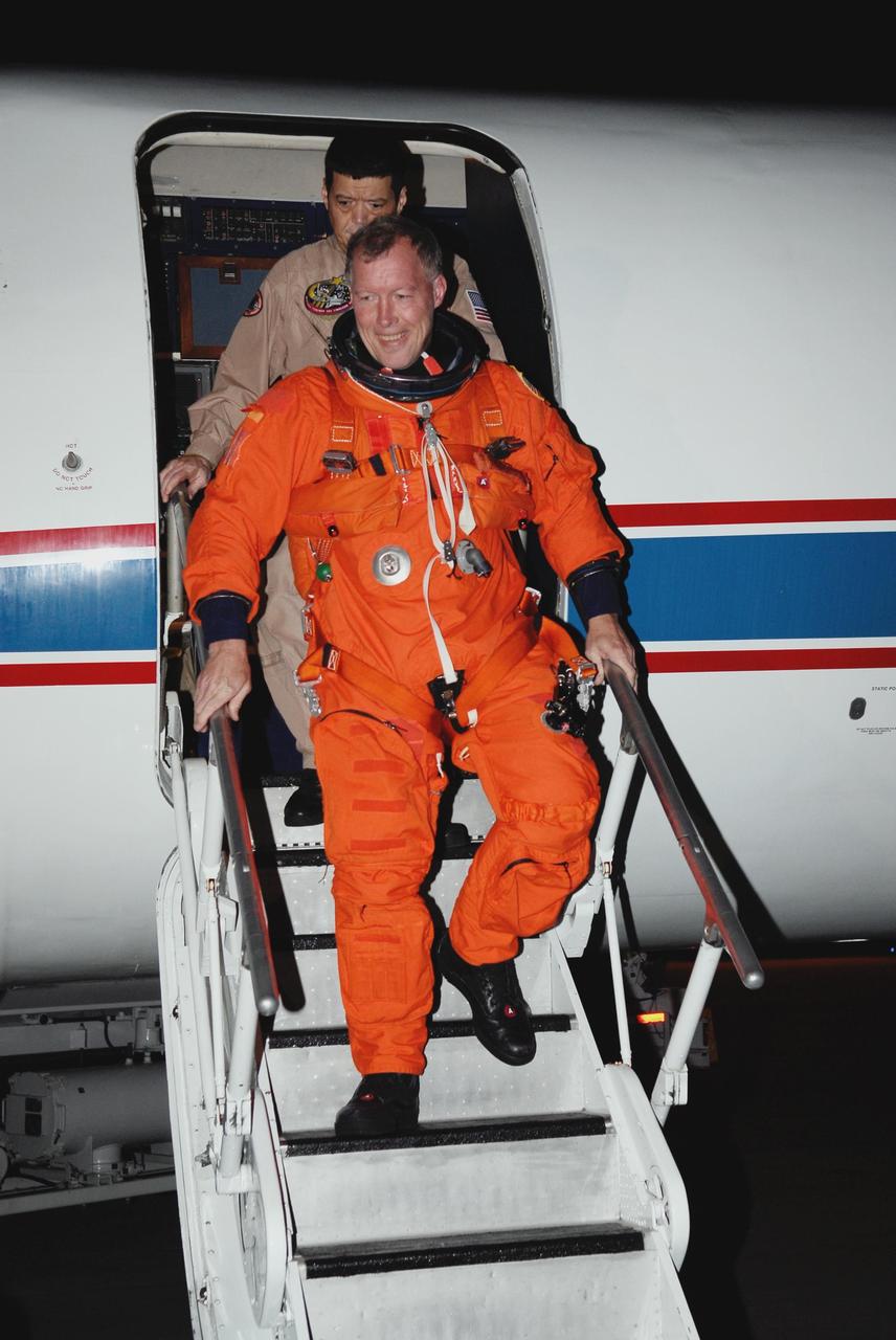 KENNEDY SPACE CENTER, FLA. -- At NASA Kennedy Space Center's Shuttle Landing Facility, STS-123 Commander Dominic Gorie disembarks from a Shuttle Training Aircraft, or STA, following a practice session of space shuttle landings.    The STA is a Grumman American Aviation-built Gulf Stream II jet that was modified to simulate an orbiter's cockpit, motion and visual cues, and handling qualities. In flight, the STA duplicates the orbiter's atmospheric descent trajectory from approximately 35,000 feet altitude to landing on a runway. Because the orbiter is unpowered during re-entry and landing, its high-speed glide must be perfectly executed the first time.  The crew for space shuttle Endeavour's STS-123 mission is at Kennedy for a full launch dress rehearsal, known as the terminal countdown demonstration test or TCDT.  The terminal countdown demonstration test provides astronauts and ground crews with an opportunity to participate in various simulated countdown activities, including equipment familiarization and emergency training. Endeavour is targeted to launch March 11 at 2:28 a.m. EDT on a 16-day mission to the International Space Station. On the mission, Endeavour and its crew will deliver the first section of the Japan Aerospace Exploration Agency's Kibo laboratory and the Canadian Space Agency's two-armed robotic system, Dextre. Photo credit: NASA/Kim Shiflett