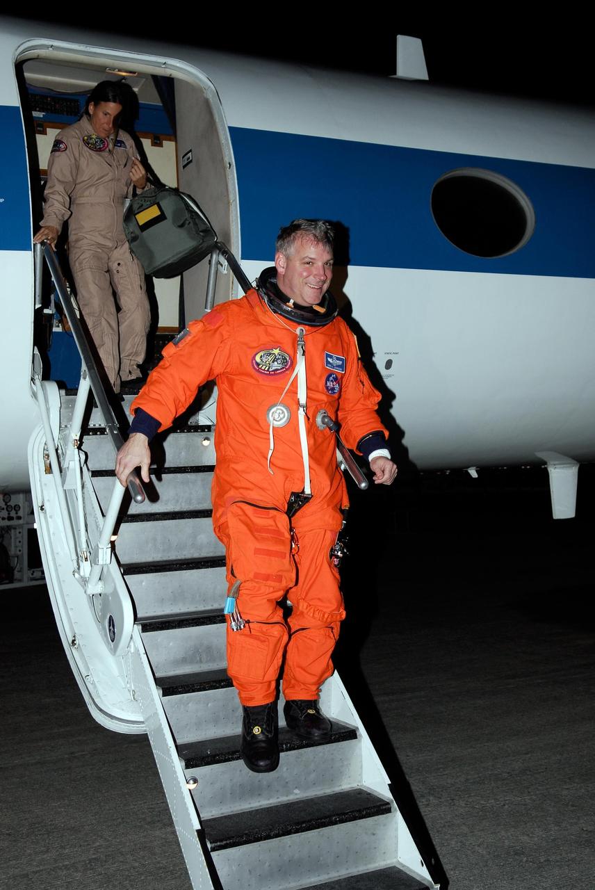 KENNEDY SPACE CENTER, FLA. -- At NASA Kennedy Space Center's Shuttle Landing Facility, STS-123 Pilot Gregory H. Johnson disembarks from a Shuttle Training Aircraft, or STA, following a practice session of space shuttle landings. The STA is a Grumman American Aviation-built Gulf Stream II jet that was modified to simulate an orbiter's cockpit, motion and visual cues, and handling qualities. In flight, the STA duplicates the orbiter's atmospheric descent trajectory from approximately 35,000 feet altitude to landing on a runway. Because the orbiter is unpowered during re-entry and landing, its high-speed glide must be perfectly executed the first time.  The crew for space shuttle Endeavour's STS-123 mission is at Kennedy for a full launch dress rehearsal, known as the terminal countdown demonstration test or TCDT.  The terminal countdown demonstration test provides astronauts and ground crews with an opportunity to participate in various simulated countdown activities, including equipment familiarization and emergency training. Endeavour is targeted to launch March 11 at 2:28 a.m. EDT on a 16-day mission to the International Space Station. On the mission, Endeavour and its crew will deliver the first section of the Japan Aerospace Exploration Agency's Kibo laboratory and the Canadian Space Agency's two-armed robotic system, Dextre. Photo credit: NASA/Kim Shiflett