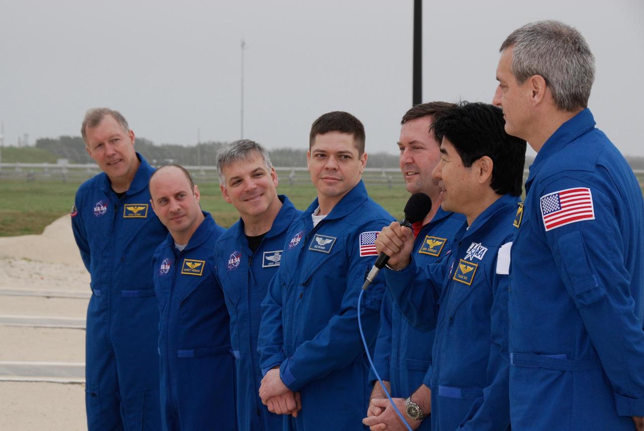 KENNEDY SPACE CENTER, FLA. -- At NASA Kennedy Space Center's Launch Pad 39A, the crew of space shuttle Endeavour's STS-123 mission answers questions from the media during a break from emergency egress training. From left are From left are Commander Dominic Gorie; Mission Specialist Garrett Reisman; Pilot Gregory H. Johnson; and Mission Specialists Robert L. Behnken, Mike Foreman, Takao Doi of the Japan Aerospace Exploration Agency and Rick Linnehan. The crew is at Kennedy for a full launch dress rehearsal, known as the terminal countdown demonstration test or TCDT. The terminal countdown demonstration test provides astronauts and ground crews with an opportunity to participate in various simulated countdown activities, including equipment familiarization and emergency training. Endeavour is targeted to launch March 11 at 2:28 a.m. EDT on a 16-day mission to the International Space Station. On the mission, Endeavour and its crew will deliver the first section of the Japan Aerospace Exploration Agency's Kibo laboratory and the Canadian Space Agency's two-armed robotic system, Dextre. Photo credit: NASA/Kim Shiflett