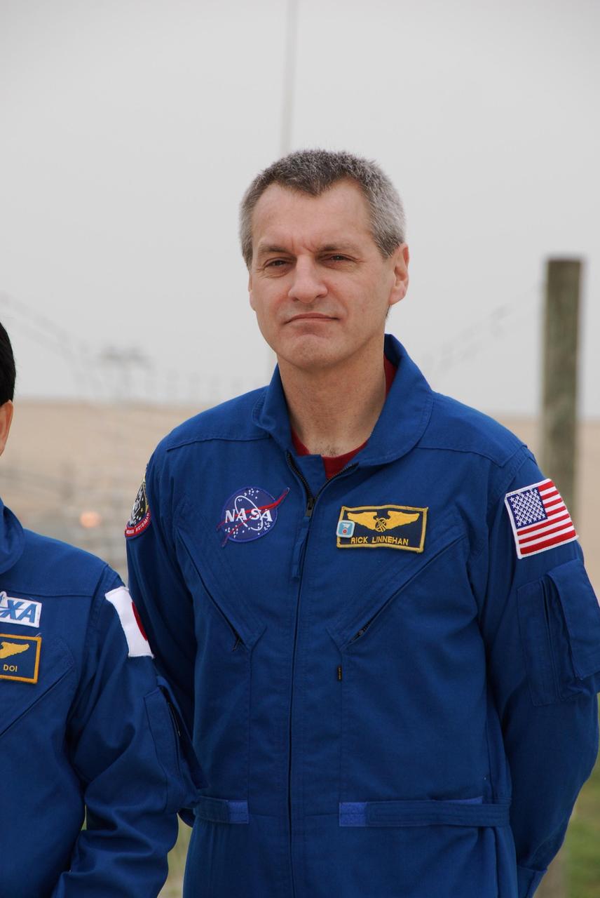 KENNEDY SPACE CENTER, FLA. -- At NASA Kennedy Space Center's Launch Pad 39A, a mission specialist on space shuttle Endeavour's STS-123 mission, Rick Linnehan, prepares to take questions from the media during a break from emergency egress training. The crew is at Kennedy for a full launch dress rehearsal, known as the terminal countdown demonstration test or TCDT. The terminal countdown demonstration test provides astronauts and ground crews with an opportunity to participate in various simulated countdown activities, including equipment familiarization and emergency training. Endeavour is targeted to launch March 11 at 2:28 a.m. EDT on a 16-day mission to the International Space Station. On the mission, Endeavour and its crew will deliver the first section of the Japan Aerospace Exploration Agency's Kibo laboratory and the Canadian Space Agency's two-armed robotic system, Dextre. Photo credit: NASA/Kim Shiflett