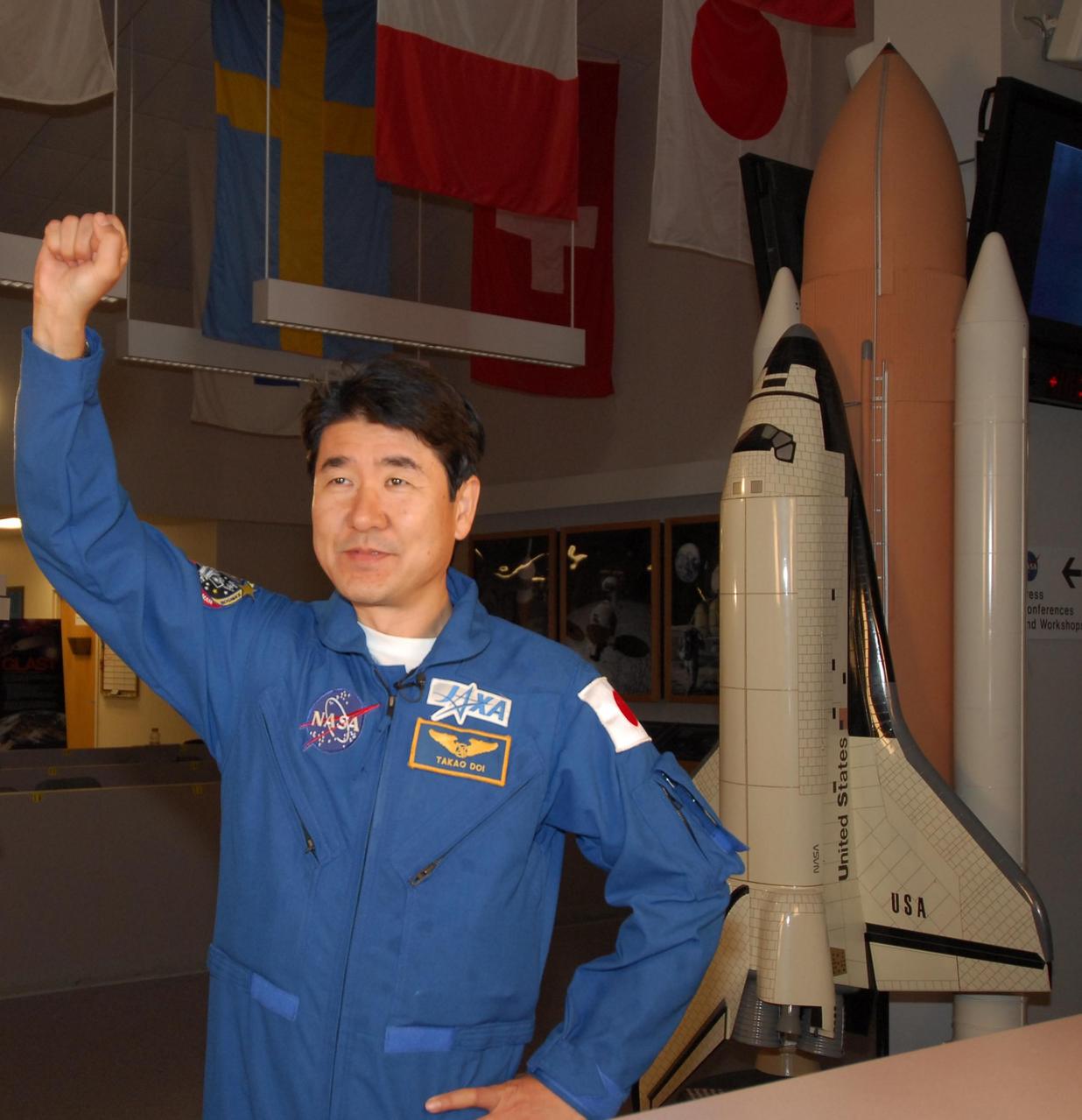 KENNEDY SPACE CENTER, FLA. -- In NASA Kennedy Space Center's News Room, STS-123 Mission Specialist Takao Doi, of the Japan Aerospace Exploration Agency, shows his enthusiasm for his upcoming flight during an interview. The crew for space shuttle Endeavour's STS-123 mission is at Kennedy for a full launch dress rehearsal, known as the terminal countdown demonstration test or TCDT. The terminal countdown demonstration test provides astronauts and ground crews with an opportunity to participate in various simulated countdown activities, including equipment familiarization and emergency training. Endeavour is targeted to launch March 11 at 2:28 a.m. EDT on a 16-day mission to the International Space Station. On the mission, Endeavour and its crew will deliver the first section of the Japan Aerospace Exploration Agency's Kibo laboratory and the Canadian Space Agency's two-armed robotic system, Dextre. Photo credit: NASA/Amanda Diller