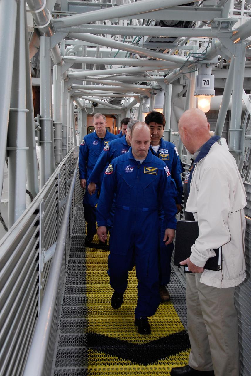 KENNEDY SPACE CENTER, FLA. -- At NASA Kennedy Space Center's Launch Pad 39A, the crew for space shuttle Endeavour's STS-123 mission traverses the exit route from the White Room during instruction on emergency egress from the pad. From back to front are Mission Specialist Mike Foreman, Commander Dominic Gorie, Pilot Gregory H. Johnson and Mission Specialists Takao Doi of the Japan Aerospace Exploration Agency and Garrett Reisman. The crew is at Kennedy for a full launch dress rehearsal, known as the terminal countdown demonstration test or TCDT. The terminal countdown demonstration test provides astronauts and ground crews with an opportunity to participate in various simulated countdown activities, including equipment familiarization and emergency training. Endeavour is targeted to launch March 11 at 2:28 a.m. EDT on a 16-day mission to the International Space Station. On the mission, Endeavour and its crew will deliver the first section of the Japan Aerospace Exploration Agency's Kibo laboratory and the Canadian Space Agency's two-armed robotic system, Dextre. Photo credit: NASA/Kim Shiflett