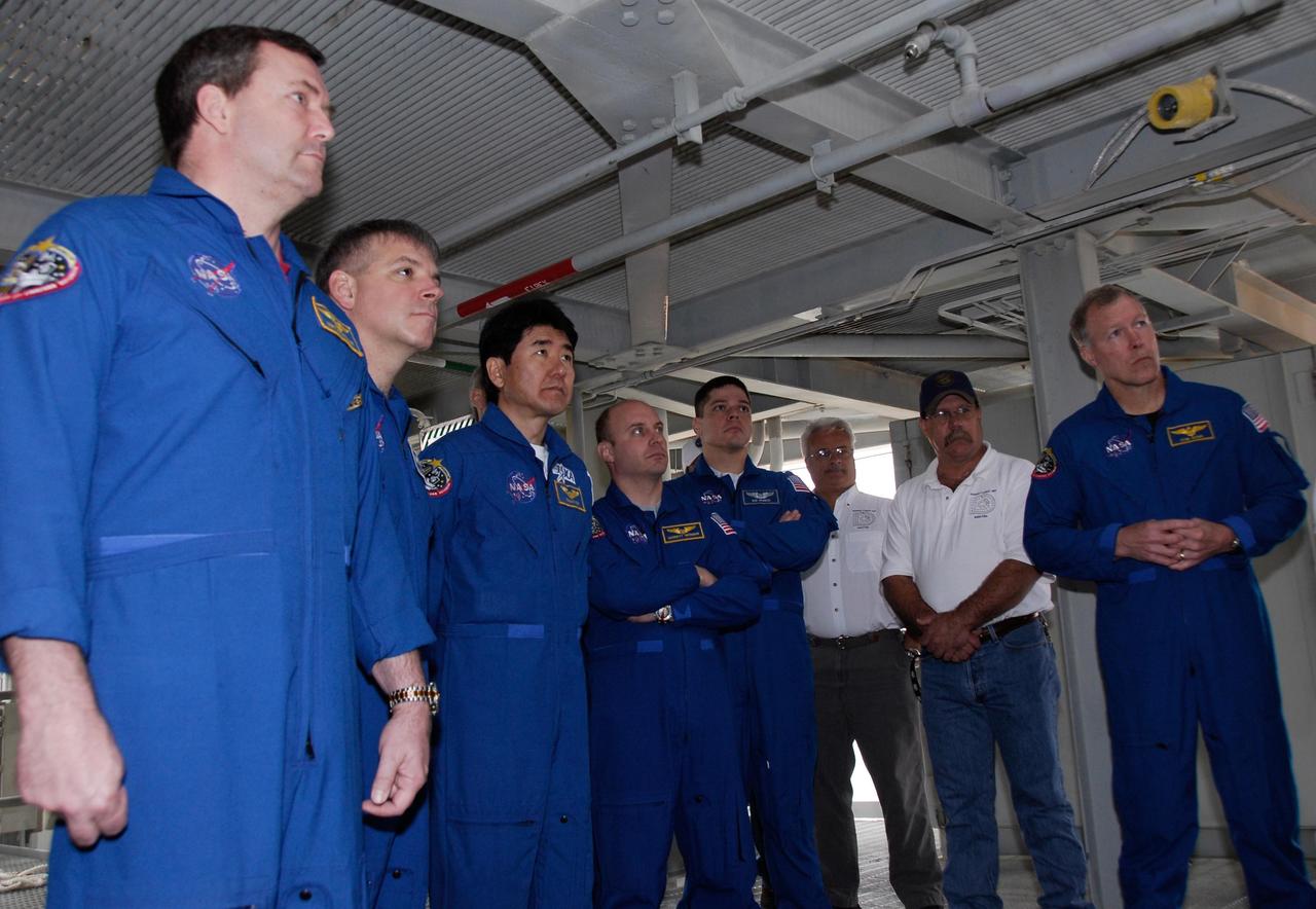 KENNEDY SPACE CENTER, FLA. -- At NASA Kennedy Space Center's Launch Pad 39A, the crew for space shuttle Endeavour's STS-123 mission receives instruction for emergency egress from the pad. In blue flight suits, from left, are Mission Specialist Mike Foreman; Pilot Gregory H. Johnson; Mission Specialists Takao Doi of the Japan Aerospace Exploration Agency, Garrett Reisman and Robert L. Behnken; and Commander Dominic Gorie. The crew is at Kennedy for a full launch dress rehearsal, known as the terminal countdown demonstration test or TCDT. The terminal countdown demonstration test provides astronauts and ground crews with an opportunity to participate in various simulated countdown activities, including equipment familiarization and emergency training. Endeavour is targeted to launch March 11 at 2:28 a.m. EDT on a 16-day mission to the International Space Station. On the mission, Endeavour and its crew will deliver the first section of the Japan Aerospace Exploration Agency's Kibo laboratory and the Canadian Space Agency's two-armed robotic system, Dextre. Photo credit: NASA/Kim Shiflett