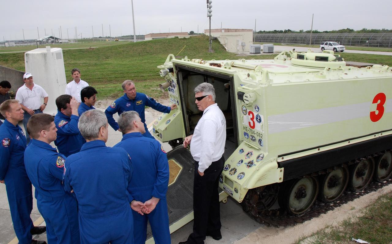 KENNEDY SPACE CENTER, FLA. -- At NASA Kennedy Space Center's Launch Pad 39A, the crew for space shuttle Endeavour's STS-123 mission receives instruction on the operation of an M-133 armored personnel carrier during emergency egress training. The crew is at Kennedy for a full launch dress rehearsal, known as the terminal countdown demonstration test or TCDT. The terminal countdown demonstration test provides astronauts and ground crews with an opportunity to participate in various simulated countdown activities, including equipment familiarization and emergency training. Endeavour is targeted to launch March 11 at 2:28 a.m. EDT on a 16-day mission to the International Space Station. On the mission, Endeavour and its crew will deliver the first section of the Japan Aerospace Exploration Agency's Kibo laboratory and the Canadian Space Agency's two-armed robotic system, Dextre. Photo credit: NASA/Kim Shiflett