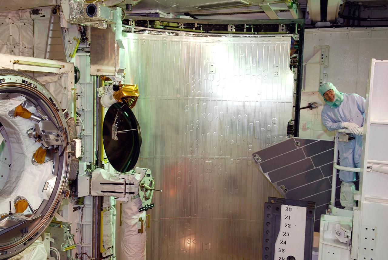 KENNEDY SPACE CENTER, FLA. -- On NASA Kennedy Space Center's Launch Pad 39A, STS-123 Mission Specialist Takao Doi looks over the payload in space shuttle Endeavour's payload bay. Doi represents the Japan Aerospace and Exploration Agency, or JAXA. He and other STS-123 crew members are at Kennedy for a full launch dress rehearsal, known as the terminal countdown demonstration test, or TCDT. The TCDT provides astronauts and ground crews with an opportunity to participate in various simulated countdown activities, including equipment familiarization and emergency training. Endeavour is targeted to launch March 11 at 2:28 a.m. EDT on the 16-day STS-123 mission to the International Space Station. Endeavour and its crew will deliver the first section of the Japan Aerospace Exploration Agency's Kibo laboratory and the Canadian Space Agency's two-armed robotic system, Dextre. Photo credit: NASA/Kim Shiflett