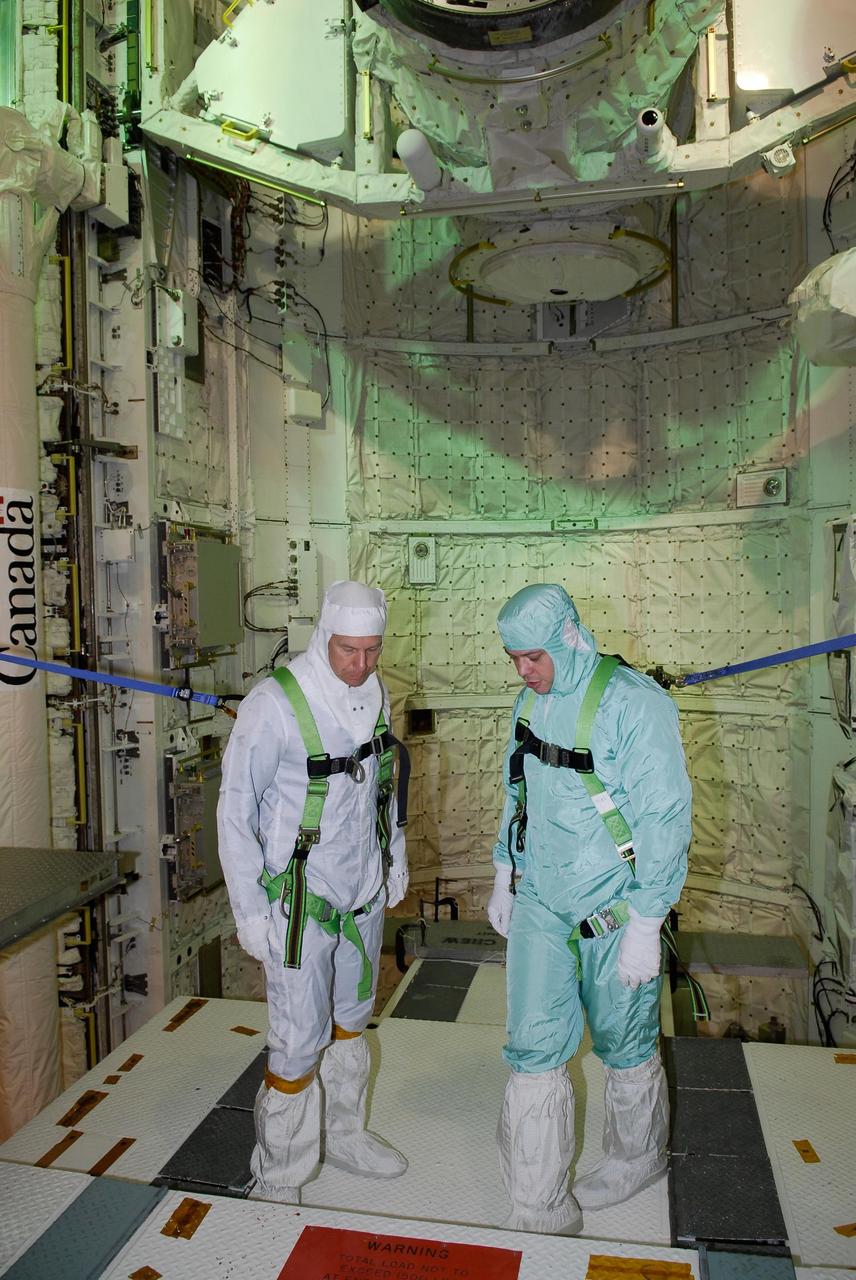 KENNEDY SPACE CENTER, FLA. -- On NASA Kennedy Space Center's Launch Pad 39A, STS-123 Mission Specialists Garrett Reisman (left) and Robert L. Behnken look over the payload in space shuttle Endeavour's payload bay. They and other STS-123 crew members are at Kennedy for a full launch dress rehearsal, known as the terminal countdown demonstration test, or TCDT. The TCDT provides astronauts and ground crews with an opportunity to participate in various simulated countdown activities, including equipment familiarization and emergency training. Endeavour is targeted to launch March 11 at 2:28 a.m. EDT on the 16-day STS-123 mission to the International Space Station. Endeavour and its crew will deliver the first section of the Japan Aerospace Exploration Agency's Kibo laboratory and the Canadian Space Agency's two-armed robotic system, Dextre. Photo credit: NASA/Kim Shiflett