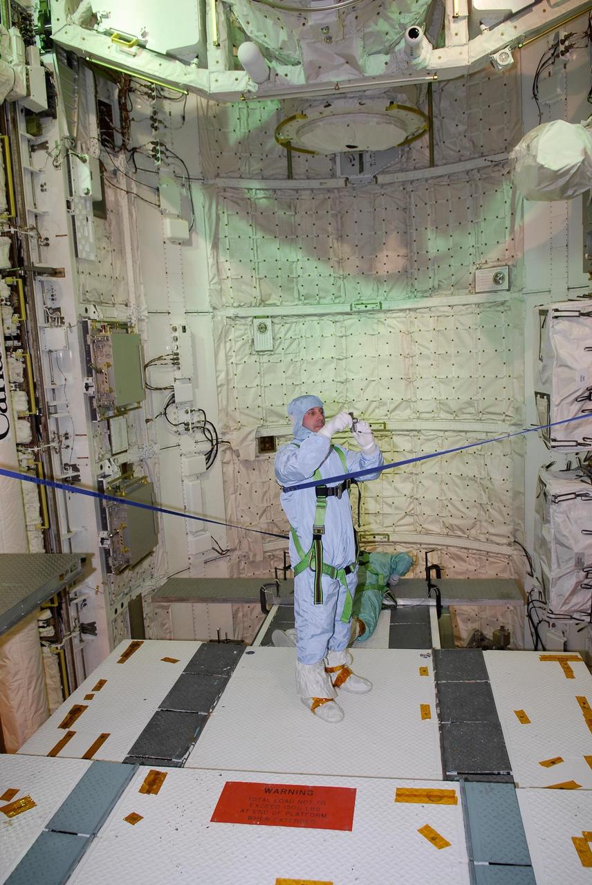 KENNEDY SPACE CENTER, FLA. -- On NASA Kennedy Space Center's Launch Pad 39A, STS-123 Mission Specialist Rick Linnehan photographs some of the payload in space shuttle Endeavour's payload bay. He and other STS-123 crew members are at Kennedy for a full launch dress rehearsal, known as the terminal countdown demonstration test, or TCDT. The TCDT provides astronauts and ground crews with an opportunity to participate in various simulated countdown activities, including equipment familiarization and emergency training. Endeavour is targeted to launch March 11 at 2:28 a.m. EDT on the 16-day STS-123 mission to the International Space Station. Endeavour and its crew will deliver the first section of the Japan Aerospace Exploration Agency's Kibo laboratory and the Canadian Space Agency's two-armed robotic system, Dextre. Photo credit: NASA/Kim Shiflett