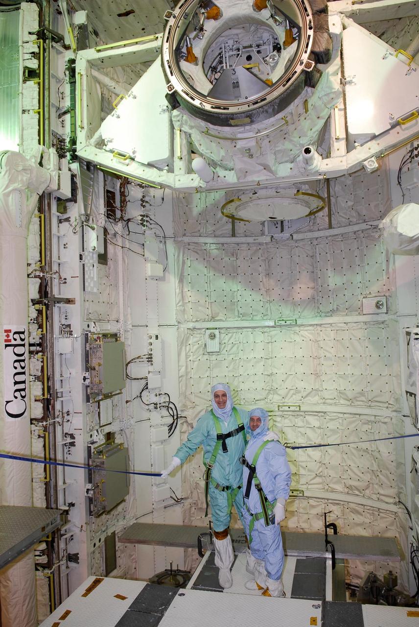 KENNEDY SPACE CENTER, FLA. -- On NASA Kennedy Space Center's Launch Pad 39A, STS-123 Mission Specialists Rick Lennehan (left) and Garrett Reisman are harnessed and tethered while they look at hardware in space shuttle Endeavour's payload bay. The STS-123 crew is at Kennedy for a full launch dress rehearsal, known as the terminal countdown demonstration test, or TCDT. The TCDT provides astronauts and ground crews with an opportunity to participate in various simulated countdown activities, including equipment familiarization and emergency training. Endeavour is targeted to launch March 11 at 2:28 a.m. EDT on the 16-day STS-123 mission to the International Space Station. Endeavour and its crew will deliver the first section of the Japan Aerospace Exploration Agency's Kibo laboratory and the Canadian Space Agency's two-armed robotic system, Dextre. Photo credit: NASA/Kim Shiflett