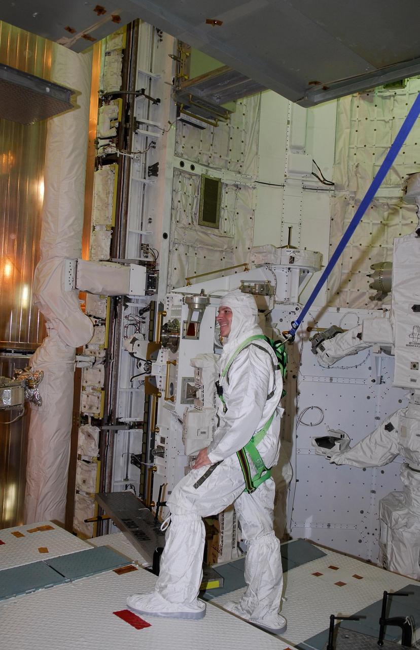 KENNEDY SPACE CENTER, FLA. -- On NASA Kennedy Space Center's Launch Pad 39A, STS-123 Pilot Gregory H. Johnson is harnessed and tethered while looking at hardware in space shuttle Endeavour's payload bay. The STS-123 crew is at Kennedy for a full launch dress rehearsal, known as the terminal countdown demonstration test, or TCDT. The TCDT provides astronauts and ground crews with an opportunity to participate in various simulated countdown activities, including equipment familiarization and emergency training. Endeavour is targeted to launch March 11 at 2:28 a.m. EDT on the 16-day STS-123 mission to the International Space Station. Endeavour and its crew will deliver the first section of the Japan Aerospace Exploration Agency's Kibo laboratory and the Canadian Space Agency's two-armed robotic system, Dextre. Photo credit: NASA/Kim Shiflett