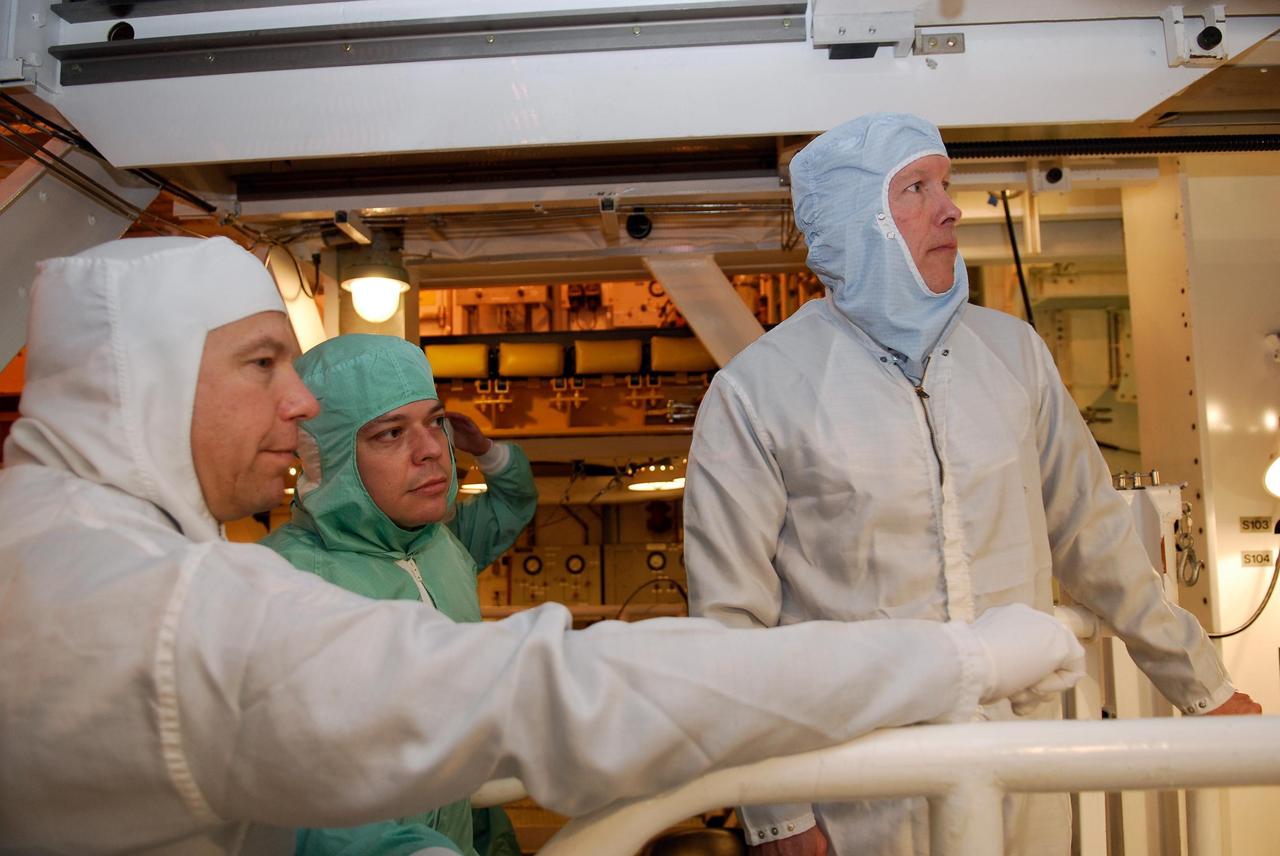 KENNEDY SPACE CENTER, FLA. -- On NASA Kennedy Space Center's Launch Pad 39A, STS-123 crew members look at hardware in space shuttle Endeavour's payload bay. From left are Mission Specialist Garrett Reisman and Robert L. Behnken and Commander Dominic Gorie. The STS-123 crew is at Kennedy for a full launch dress rehearsal, known as the terminal countdown demonstration test, or TCDT. The TCDT provides astronauts and ground crews with an opportunity to participate in various simulated countdown activities, including equipment familiarization and emergency training. Endeavour is targeted to launch March 11 at 2:28 a.m. EDT on the 16-day STS-123 mission to the International Space Station. Endeavour and its crew will deliver the first section of the Japan Aerospace Exploration Agency's Kibo laboratory and the Canadian Space Agency's two-armed robotic system, Dextre. Photo credit: NASA/Kim Shiflett