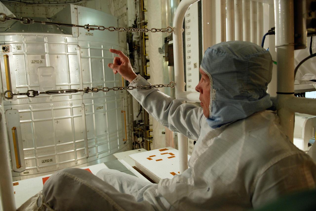 KENNEDY SPACE CENTER, FLA. -- On NASA Kennedy Space Center's Launch Pad 39A, STS-123 Commander Dominic Gorie takes a close look at the payload in space shuttle Endeavour's payload bay. He and other STS-123 crew members are at Kennedy for a full launch dress rehearsal, known as the terminal countdown demonstration test, or TCDT. The TCDT provides astronauts and ground crews with an opportunity to participate in various simulated countdown activities, including equipment familiarization and emergency training. Endeavour is targeted to launch March 11 at 2:28 a.m. EDT on the 16-day STS-123 mission to the International Space Station. Endeavour and its crew will deliver the first section of the Japan Aerospace Exploration Agency's Kibo laboratory and the Canadian Space Agency's two-armed robotic system, Dextre. Photo credit: NASA/Kim Shiflett
