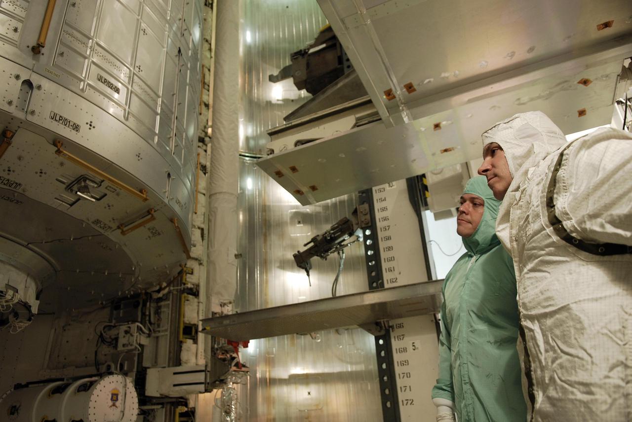 KENNEDY SPACE CENTER, FLA. -- On NASA Kennedy Space Center's Launch Pad 39A, STS-123 Mission Specialist Robert L. Behnken (left) and Pilot Gregory Johnson look over the payload in space shuttle Endeavour's payload bay. They and other STS-123 crew members are at Kennedy for a full launch dress rehearsal, known as the terminal countdown demonstration test, or TCDT. The TCDT provides astronauts and ground crews with an opportunity to participate in various simulated countdown activities, including equipment familiarization and emergency training. Endeavour is targeted to launch March 11 at 2:28 a.m. EDT on the 16-day STS-123 mission to the International Space Station. Endeavour and its crew will deliver the first section of the Japan Aerospace Exploration Agency's Kibo laboratory and the Canadian Space Agency's two-armed robotic system, Dextre. Photo credit: NASA/Kim Shiflett