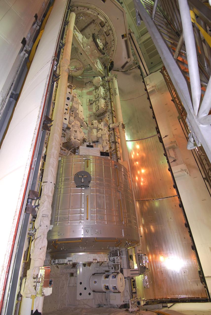 KENNEDY SPACE CENTER, FLA. --   On NASA Kennedy Space Center's Launch Pad 39A, one of space shuttle Endeavour's payload bay doors, at left, is closing to prepare for launch.  Seen at the bottom is the first section of the Japan Aerospace Exploration Agency's Kibo laboratory, the Experiment Logistics Module Pressurized Section, or ELM-PS.  Endeavour is targeted to launch March 11 at 2:28 a.m. EDT on the 16-day STS-123 mission to the International Space Station. Endeavour and its crew will deliver the ELM-PS and the Canadian Space Agency's two-armed robotic system, Dextre.   Photo credit: NASA/Dimitri Gerondidakis