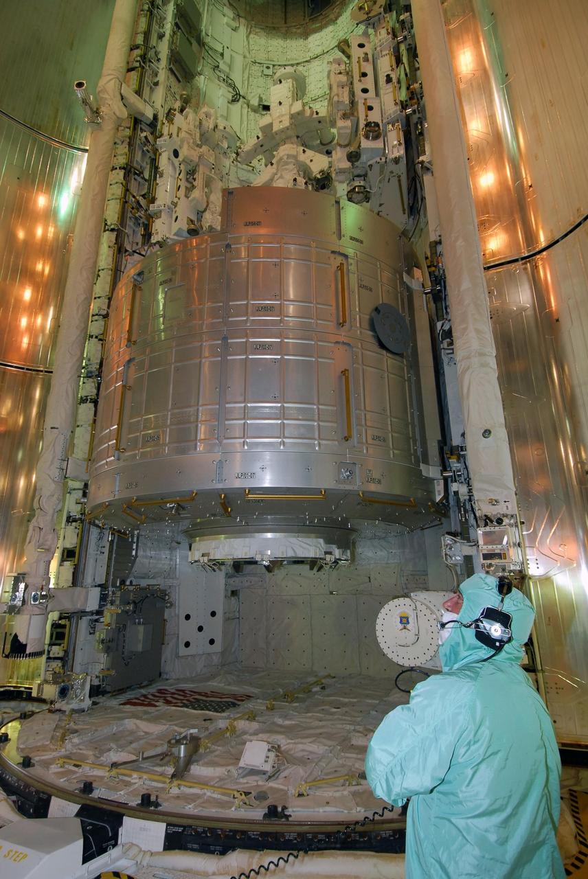 KENNEDY SPACE CENTER, FLA. --   On NASA Kennedy Space Center's Launch Pad 39A, a worker keeps watch as space shuttle Endeavour's payload bay doors begin closing for launch.  Seen at the bottom of the payload bay is the first section of the Japan Aerospace Exploration Agency's Kibo laboratory, the Experiment Logistics Module Pressurized Section, or ELM-PS.  Endeavour is targeted to launch March 11 at 2:28 a.m. EDT on the 16-day STS-123 mission to the International Space Station. Endeavour and its crew will deliver the ELM-PS and the Canadian Space Agency's two-armed robotic system, Dextre.   Photo credit: NASA/Dimitri Gerondidakis