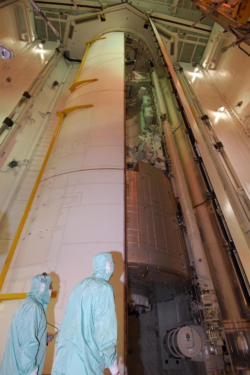 KENNEDY SPACE CENTER, FLA. --   On NASA Kennedy Space Center's Launch Pad 39A, two workers keep watch as the second payload bay door closes on space shuttle Endeavour.  Still seen, at the bottom of the payload bay, is the first section of the Japan Aerospace Exploration Agency's Kibo laboratory, the Experiment Logistics Module Pressurized Section, or ELM-PS.  Endeavour is targeted to launch March 11 at 2:28 a.m. EDT on the 16-day STS-123 mission to the International Space Station. Endeavour and its crew will deliver the ELM-PS and the Canadian Space Agency's two-armed robotic system, Dextre.   Photo credit: NASA/Dimitri Gerondidakis