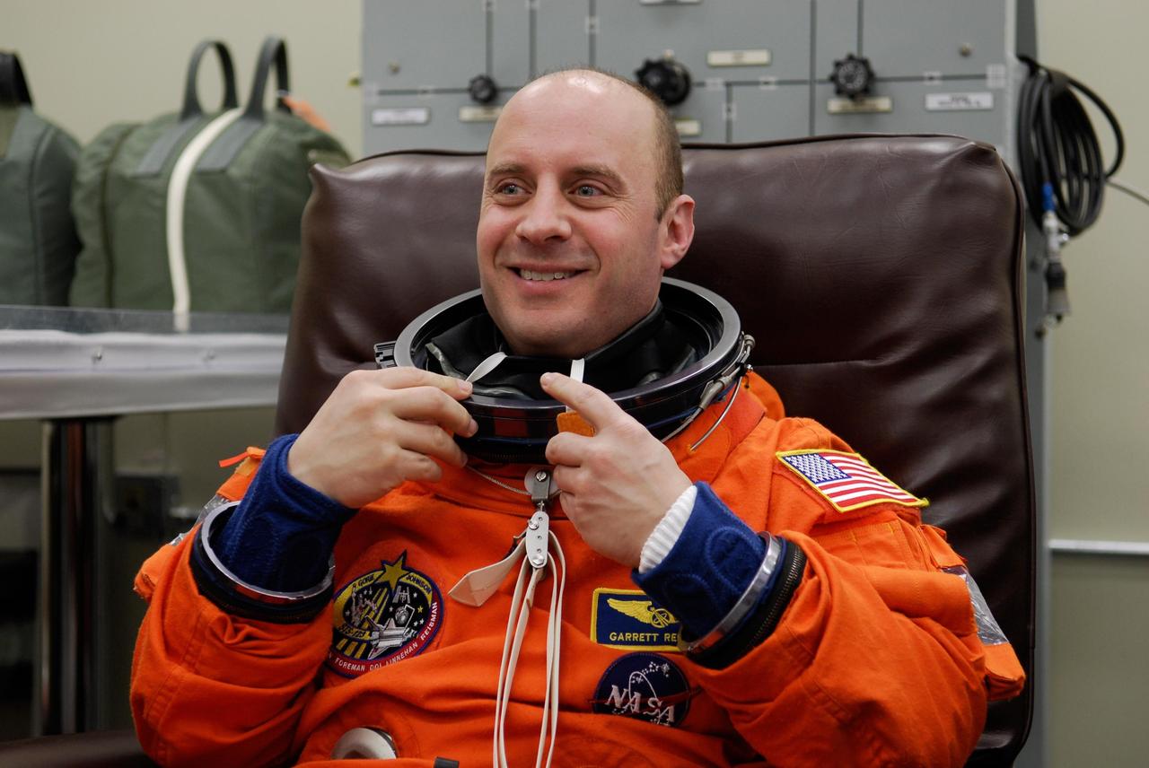 KENNEDY SPACE CENTER, FLA. --   STS-123 Mission Specialist Garrett Reisman dons his launch and entry suit for the launch dress rehearsal, culmination of the terminal countdown demonstration test, or TCDT.The TCDT provides astronauts and ground crews with an opportunity to participate in various simulated countdown activities, including equipment familiarization and emergency training. Space shuttle Endeavour is targeted to launch March 11 at 2:28 a.m. EDT on the 16-day STS-123 mission to the International Space Station.  Endeavour and its crew will deliver the first section of the Japan Aerospace Exploration Agency's Kibo laboratory and the Canadian Space Agency's two-armed robotic system, Dextre.   Photo credit: NASA/Kim Shiflett