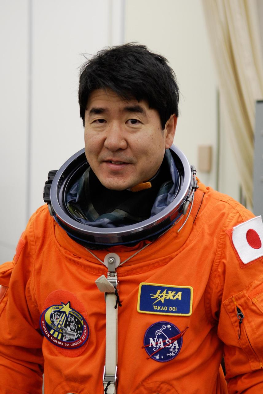 KENNEDY SPACE CENTER, FLA. -- STS-123 Mission Specialist Takao Doi suits up for the launch dress rehearsal, culmination of the terminal countdown demonstration test, or TCDT. Doi represents the Japan Aerospace Exploration Agency, or JAXA. The TCDT provides astronauts and ground crews with an opportunity to participate in various simulated countdown activities, including equipment familiarization and emergency training. Space shuttle Endeavour is targeted to launch March 11 at 2:28 a.m. EDT on the 16-day STS-123 mission to the International Space Station. Endeavour and its crew will deliver the first section of the Japan Aerospace Exploration Agency's Kibo laboratory and the Canadian Space Agency's two-armed robotic system, Dextre. Photo credit: NASA/Kim Shiflett