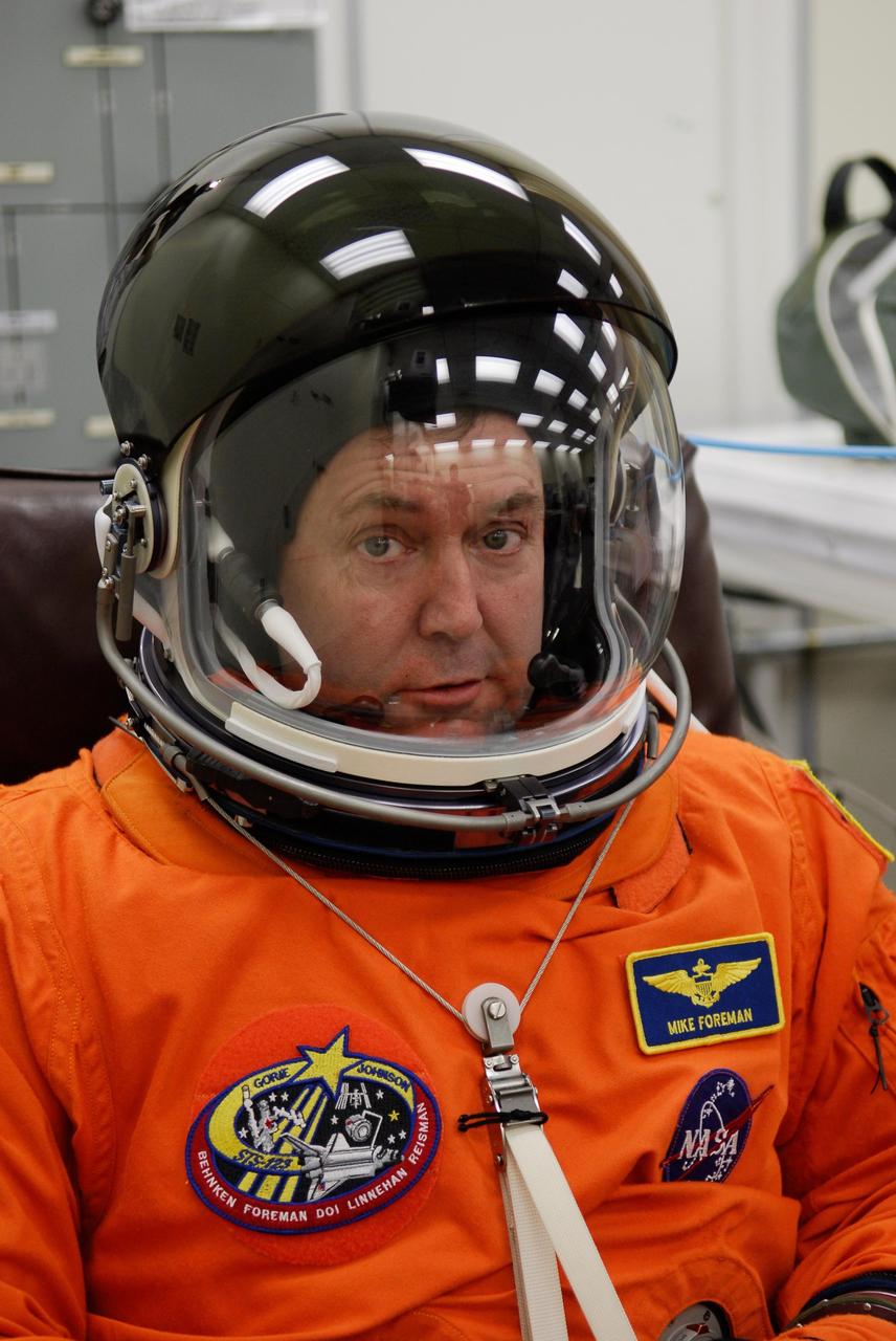 KENNEDY SPACE CENTER, FLA. --  STS-123 Mission Specialist Mike Foreman tests the communications in his helmet before the launch dress rehearsal, culmination of the terminal countdown demonstration test, or TCDT.  The TCDT provides astronauts and ground crews with an opportunity to participate in various simulated countdown activities, including equipment familiarization and emergency training. Space shuttle Endeavour is targeted to launch March 11 at 2:28 a.m. EDT on the 16-day STS-123 mission to the International Space Station.  Endeavour and its crew will deliver the first section of the Japan Aerospace Exploration Agency's Kibo laboratory and the Canadian Space Agency's two-armed robotic system, Dextre.   Photo credit: NASA/Kim Shiflett