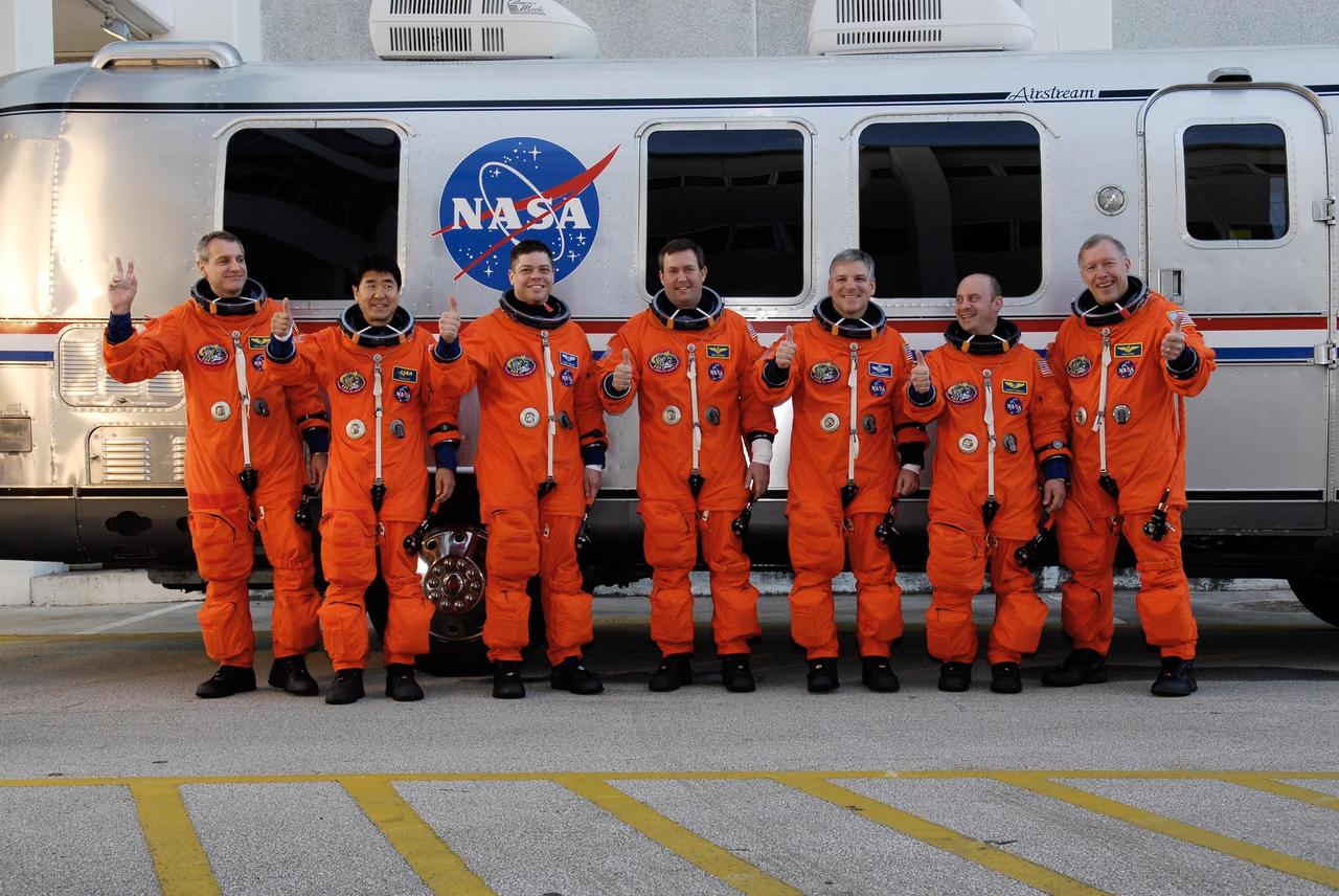 KENNEDY SPACE CENTER, FLA. -- The crew of mission STS-123 show their readiness to take part in a simulated launch countdown, the culmination of the terminal countdown demonstration test, or TCDT. From left are Mission Specialists Rick Linnehan, Takao Doi, Robert L. Behnken and Mike Foreman, Pilot Gregory H. Johnson, Mission Specialist Garrett Reisman and Commander Dominic Gorie. The TCDT provides astronauts and ground crews with an opportunity to participate in various simulated countdown activities, including equipment familiarization and emergency training. Space shuttle Endeavour is targeted to launch March 11 at 2:28 a.m. EDT on the 16-day STS-123 mission to the International Space Station. Endeavour and its crew will deliver the first section of the Japan Aerospace Exploration Agency's Kibo laboratory and the Canadian Space Agency's two-armed robotic system, Dextre. Photo credit: NASA/Kim Shiflett
