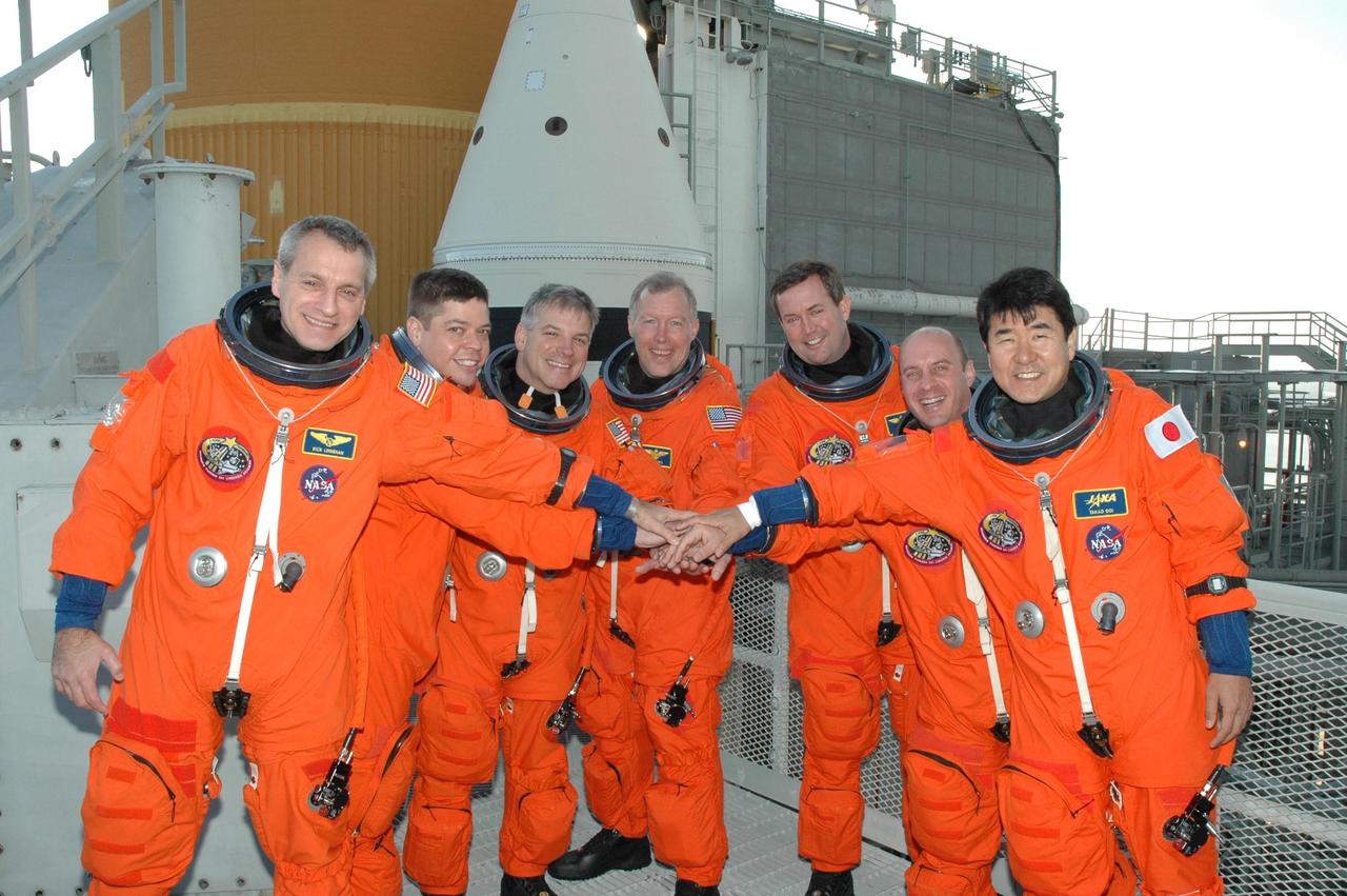 KENNEDY SPACE CENTER, FLA. -- Before the simulated launch countdown in space shuttle Endeavour, the STS-123 crew gathers near the top of the fixed service structure on NASA Kennedy Space Center's Launch Pad 39A. Seen from left are Mission Specialists Rick Linnehan and Robert L. Behnken, Pilot Gregory H. Johnson, Commander Dominic Gorie and Mission Specialists Mike Foreman, Garrett Reisman and Takao Doi. The countdown is the culmination of the terminal countdown demonstration test, or TCDT. The TCDT provides astronauts and ground crews with an opportunity to participate in various countdown activities, including equipment familiarization and emergency egress training. Endeavour is targeted to launch at 2:28 a.m. EDT March 11 on the 16-day STS-123 mission to the International Space Station. Endeavour and its crew will deliver the first section of the Japan Aerospace Exploration Agency's Kibo laboratory and the Canadian Space Agency's two-armed robotic system, Dextre. Photo credit: NASA/Jim Grossmann