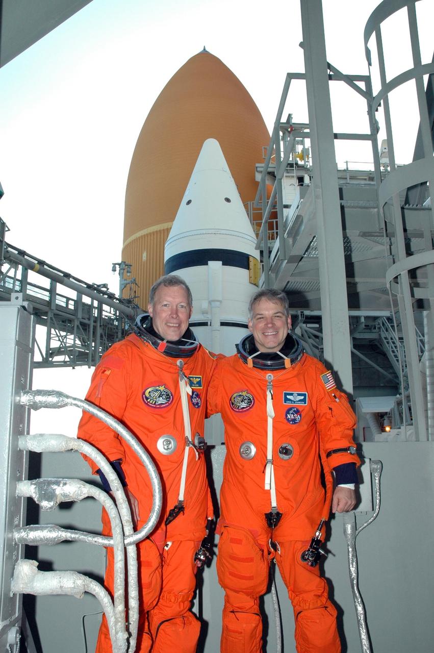 KENNEDY SPACE CENTER, FLA. --  Before the simulated launch countdown in space shuttle Endeavour, STS-123 Commander Dominic Gorie (left) and Pilot Gregory H. Johnson pose in front of Endeavour's solid rocket booster and external tank on NASA Kennedy Space Center's Launch Pad 39A. The countdown is the culmination of the terminal countdown demonstration test, or TCDT. The TCDT provides astronauts and ground crews with an opportunity to participate in various countdown activities, including equipment familiarization and emergency egress training. Endeavour is targeted to launch at 2:28 a.m. EDT March 11 on the 16-day STS-123 mission to the International Space Station.  Endeavour and its crew will deliver the first section of the Japan Aerospace Exploration Agency's Kibo laboratory and the Canadian Space Agency's two-armed robotic system, Dextre.   Photo credit: NASA/Jim Grossmann