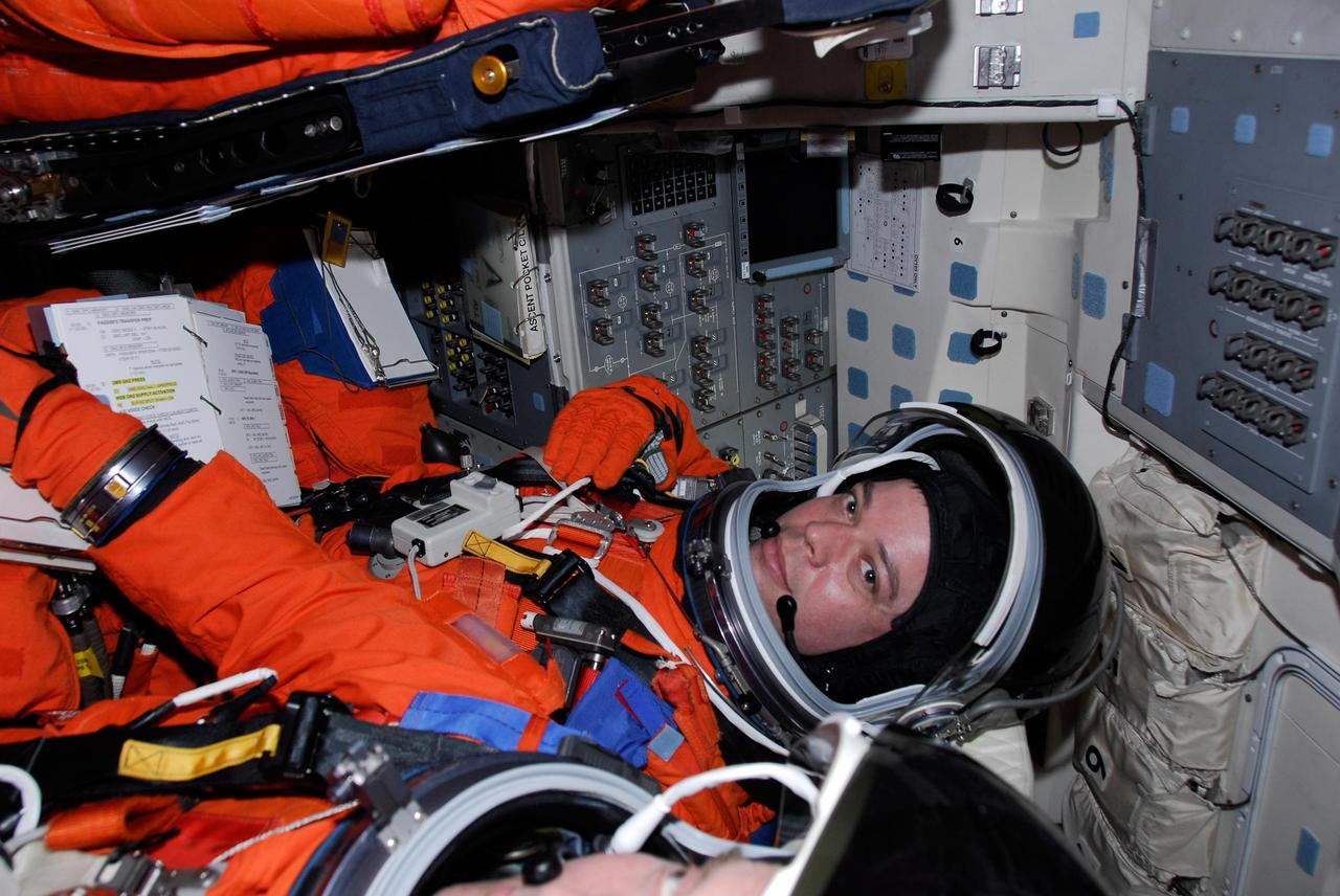 KENNEDY SPACE CENTER, FLA. -- Inside space shuttle Endeavour, STS-123 Mission Specialist Robert L. Behnken goes through a checklist for the simulated launch countdown, which is the culmination of the terminal countdown demonstration test, or TCDT. The TCDT provides astronauts and ground crews with an opportunity to participate in various countdown activities, including equipment familiarization and emergency egress training. Endeavour is targeted to launch at 2:28 a.m. EDT March 11 on the 16-day STS-123 mission to the International Space Station. Endeavour and its crew will deliver the first section of the Japan Aerospace Exploration Agency's Kibo laboratory and the Canadian Space Agency's two-armed robotic system, Dextre. Photo credit: NASA/Kim Shiflett