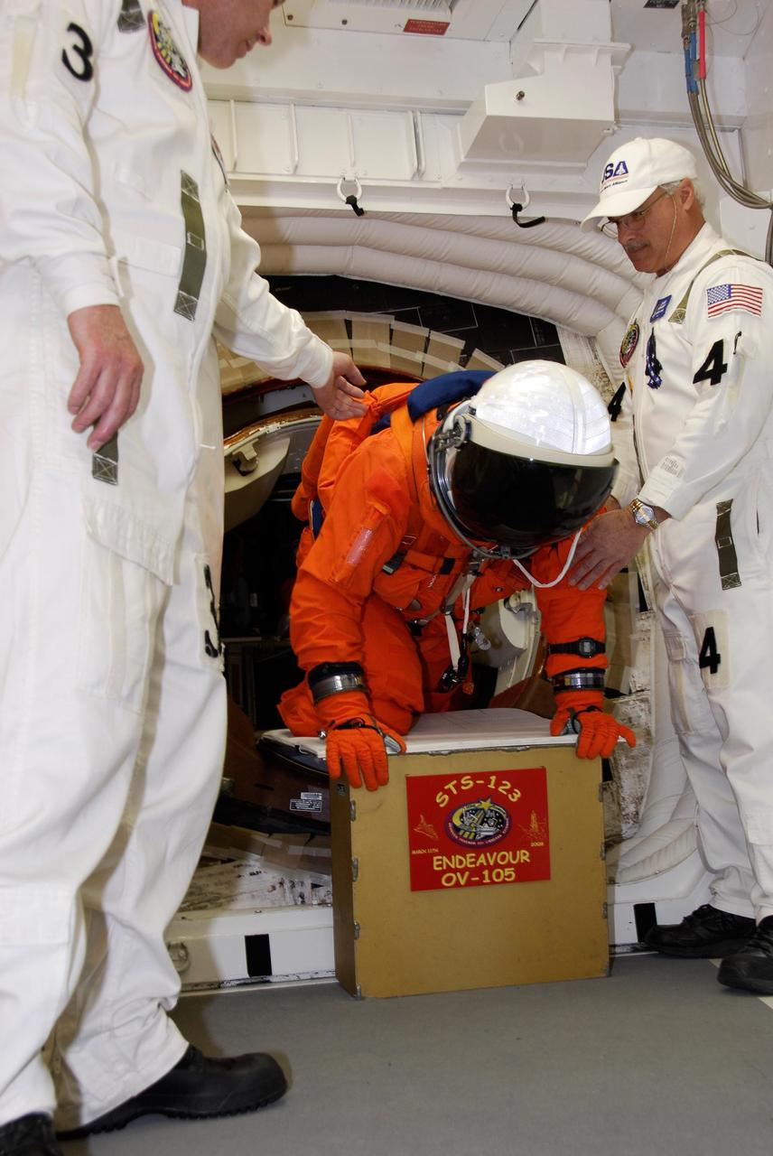 KENNEDY SPACE CENTER, FLA. -- Following the simulated launch countdown, STS-123 crew members begin exiting space shuttle Endeavour into the White Room on Launch Pad 39 at NASA's Kennedy Space Center. To leave the pad, the STS-123 crew will practice emergency egress using the slidewire baskets. The countdown was the culmination of the terminal countdown demonstration test, or TCDT. The TCDT provides astronauts and ground crews with an opportunity to participate in various countdown activities, including equipment familiarization and emergency egress training. Endeavour is targeted to launch at 2:28 a.m. EDT March 11 on the 16-day STS-123 mission to the International Space Station. Endeavour and its crew will deliver the first section of the Japan Aerospace Exploration Agency's Kibo laboratory and the Canadian Space Agency's two-armed robotic system, Dextre. Photo credit: NASA/Kim Shiflett
