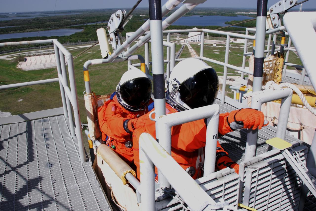 KENNEDY SPACE CENTER, FLA. -- Following the simulated launch countdown, STS-123 crew members are ready to release the slidewire basket on Launch Pad 39 at NASA's Kennedy Space Center. The crew is practicing emergency egress from the pad. The countdown was the culmination of the terminal countdown demonstration test, or TCDT. The TCDT provides astronauts and ground crews with an opportunity to participate in various countdown activities, including equipment familiarization and emergency egress training. Endeavour is targeted to launch at 2:28 a.m. EDT March 11 on the 16-day STS-123 mission to the International Space Station. Endeavour and its crew will deliver the first section of the Japan Aerospace Exploration Agency's Kibo laboratory and the Canadian Space Agency's two-armed robotic system, Dextre. Photo credit: NASA/Kim Shiflett